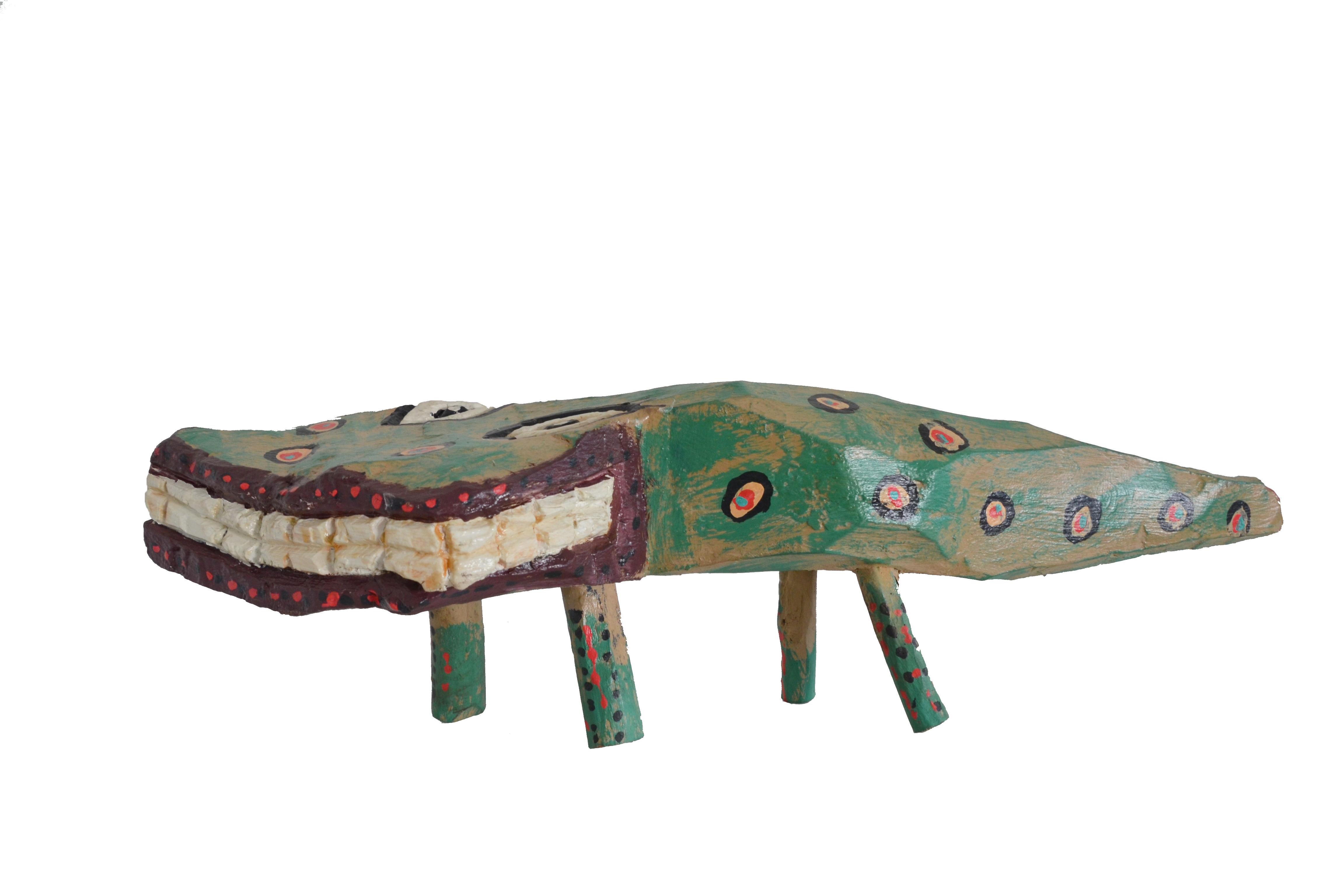This is a hand-carved and hand-painted wooden sculpture, representing a reptile found in Brazil. The artist, Iris, from the Association Mestre Noza, becomes from Juazeiro do Norte, Ceará, Brazil, where the piece was also made. This is a great