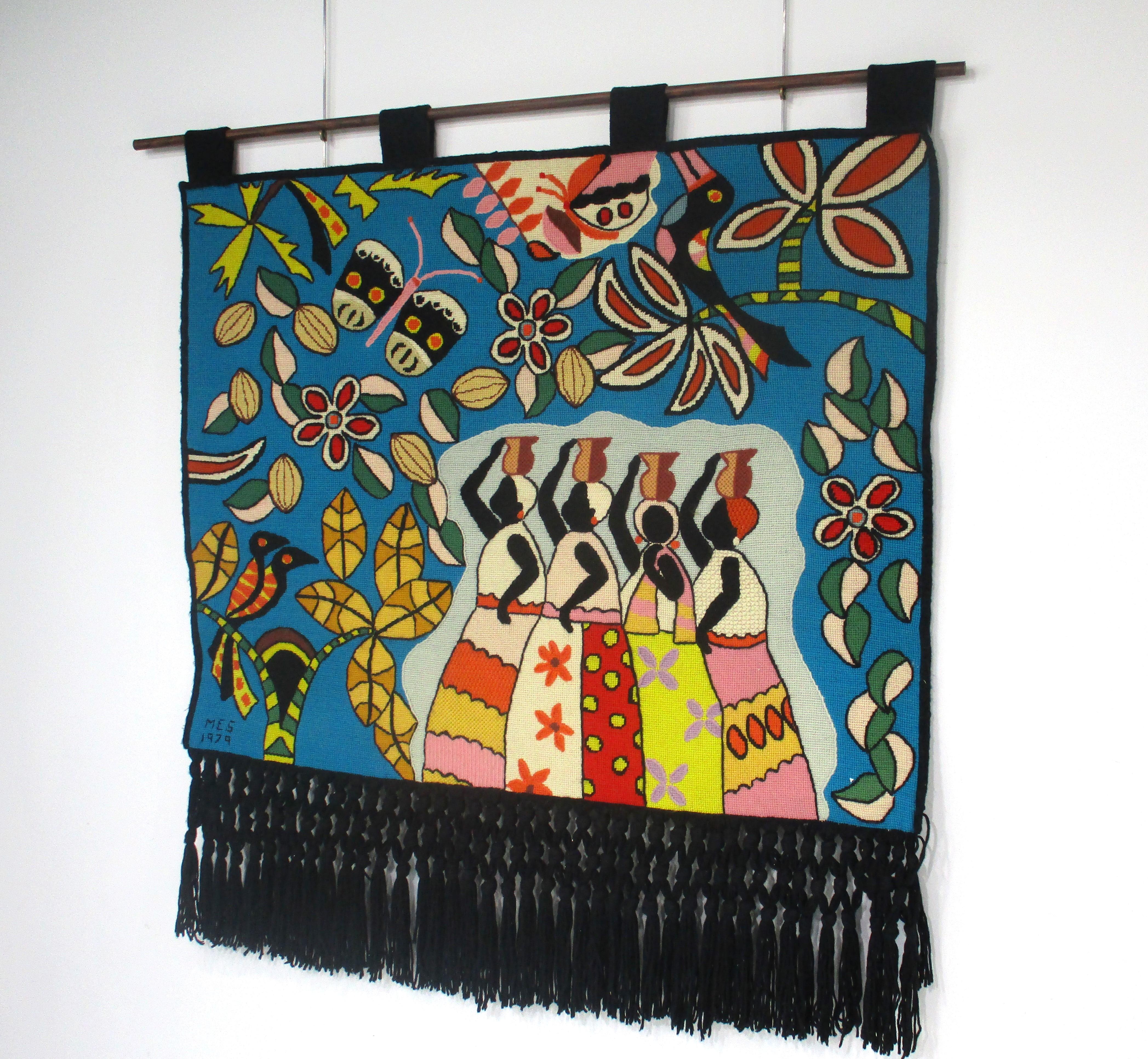 A large colorful and very well crafted hand woven tapestry wall hanging depicting lush rich flowers , butterflies , plants and women in the marketplace . Celebrating the Afro - Baiana cultural heritage of the artists that craft these fine pieces .