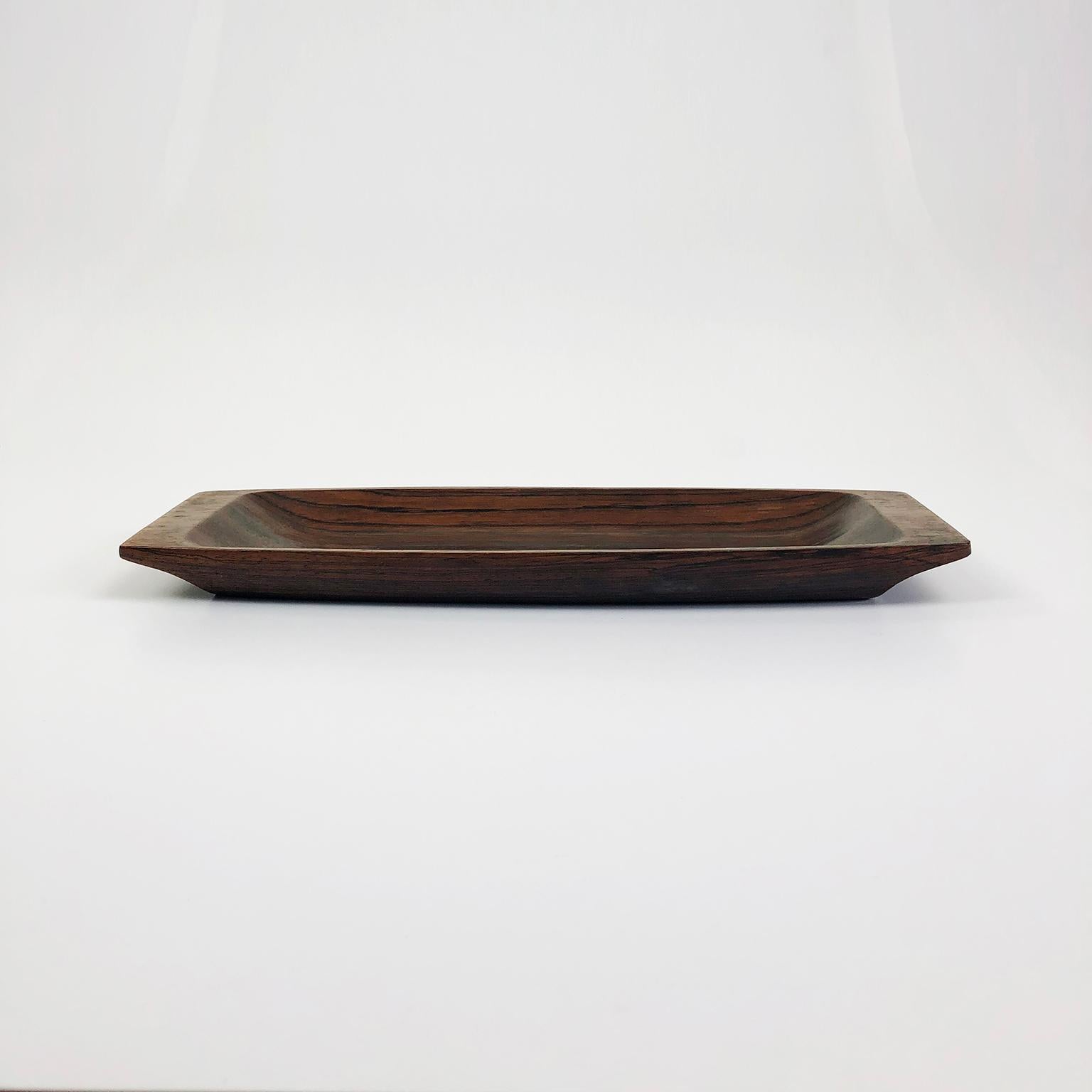 We offer this Brazilian Jacaranda wood tray designed by Jean Gillon, circa 1960. Excellent vintage condition, very minor scratches on underside consistent with age and use. Includes original label of Wood Art with 1 of 205 serial number.