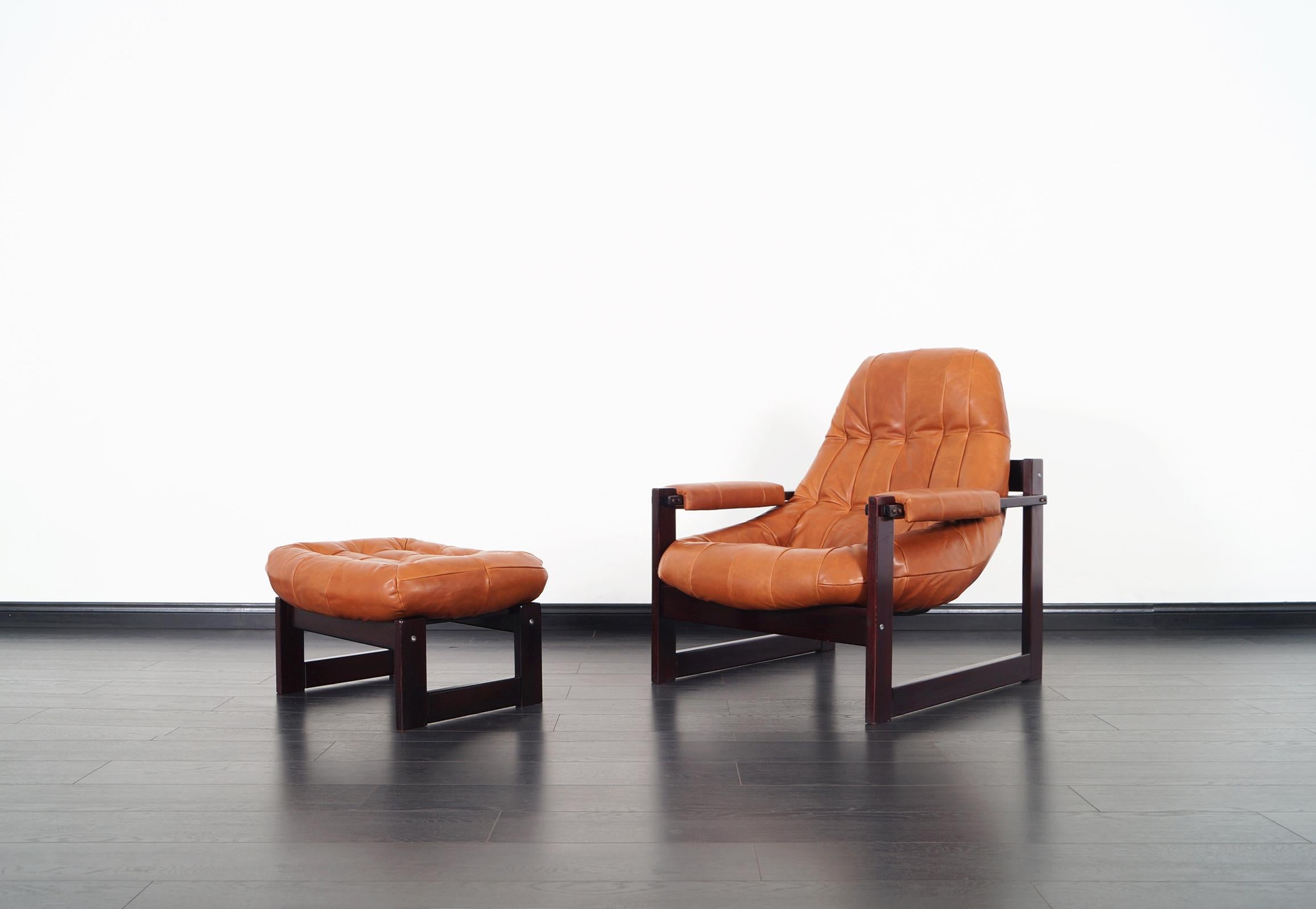 Vintage Brazilian leather lounge chair and ottoman designed by Percival Lafer. The chair and ottoman are both supported by solid Brazilian rosewood bases that shows clean lines and great craftsmanship.
