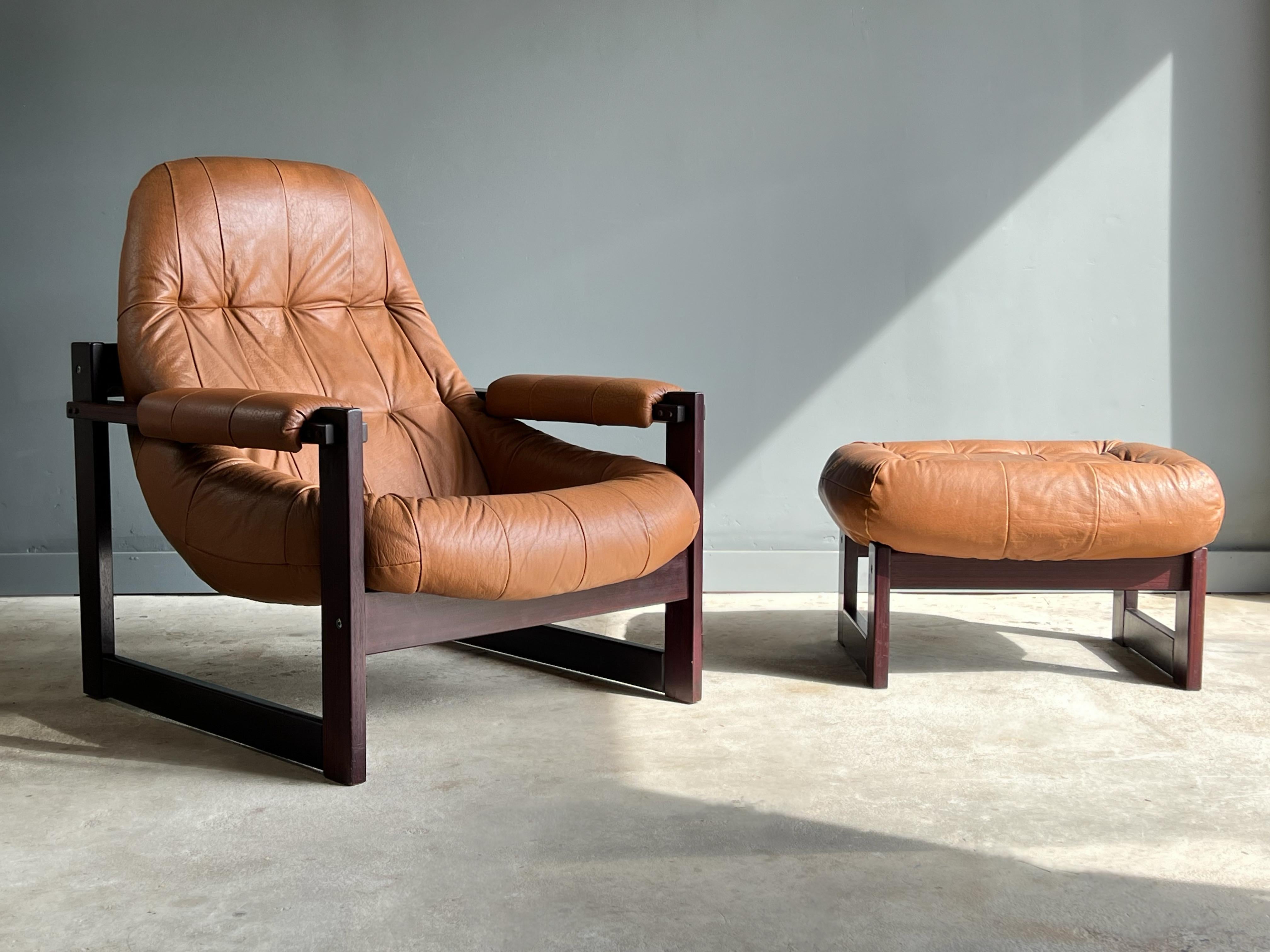 Lovely tall back jatoba wood and leather lounge chair and ottoman designed by Percival Lafer, in original cognac leather, Brazil, 1970's, produced by Lafer MP, model MP-167.