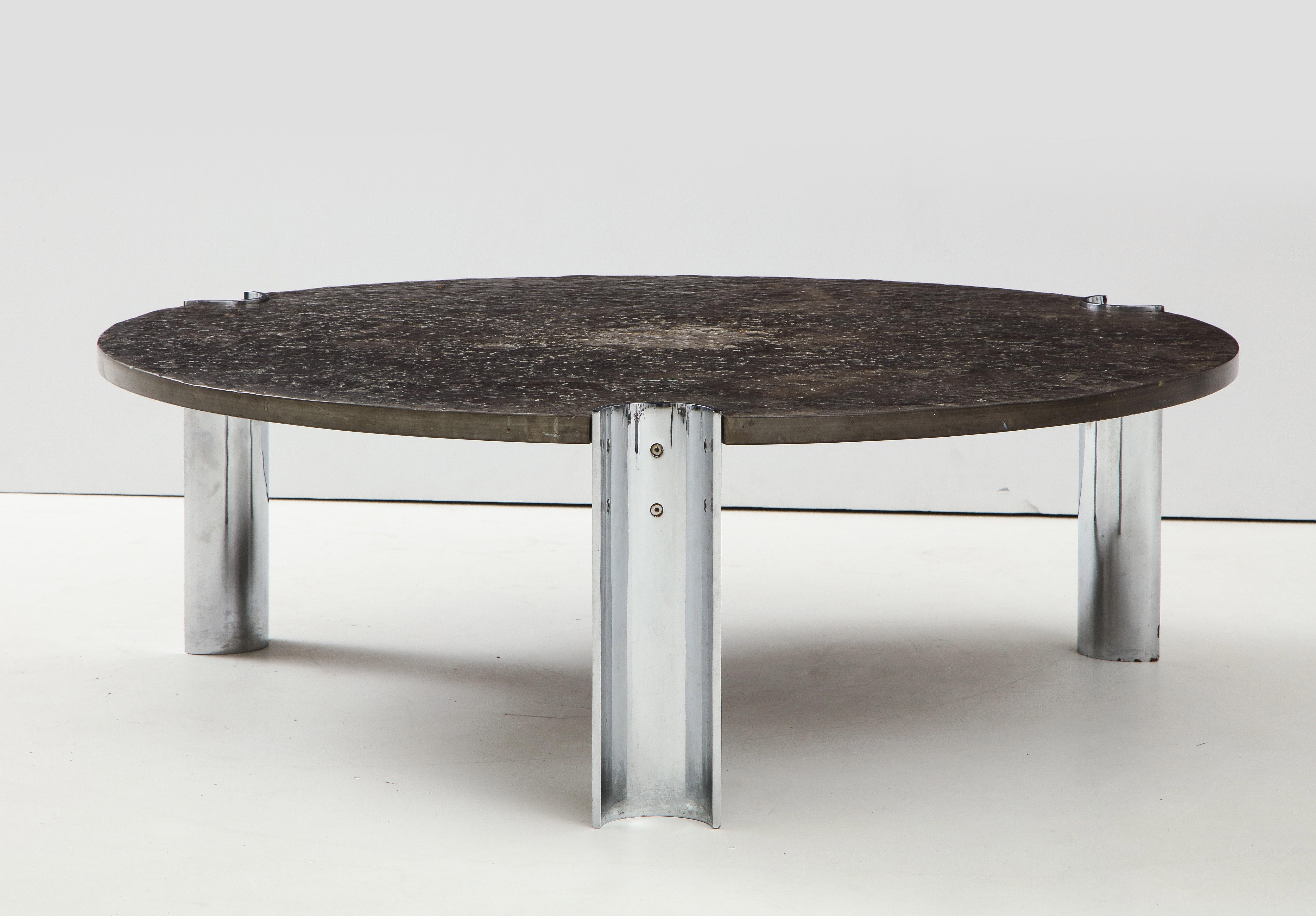 Brazilian Limestone and chrome coffee table. The rough, organic texture of the limestone slab gives the strong, industrial design an extra dimension.
