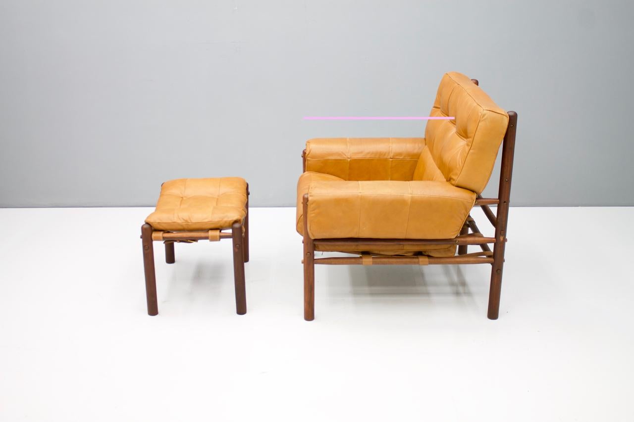Brazilian lounge chairs with ottoman in cognac brown leather 1970s.
Very good condition

Measurements:
Chair: W 89 cm, H 88 cm, D 82 cm, SH 43 cm
Ottoman: W 61 cm, D 39 cm, H 40 cm.