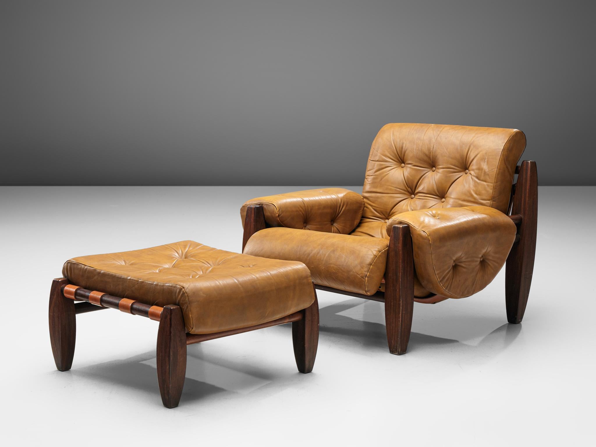 Lounge chair with ottoman, leather and Brazilian hardwood, Brazil, 1970s

A bulky lounge chair with ottoman that contains the characteristics of Brazilian modern furniture design. Made of traditional materials such us solid Brazilian wood. The