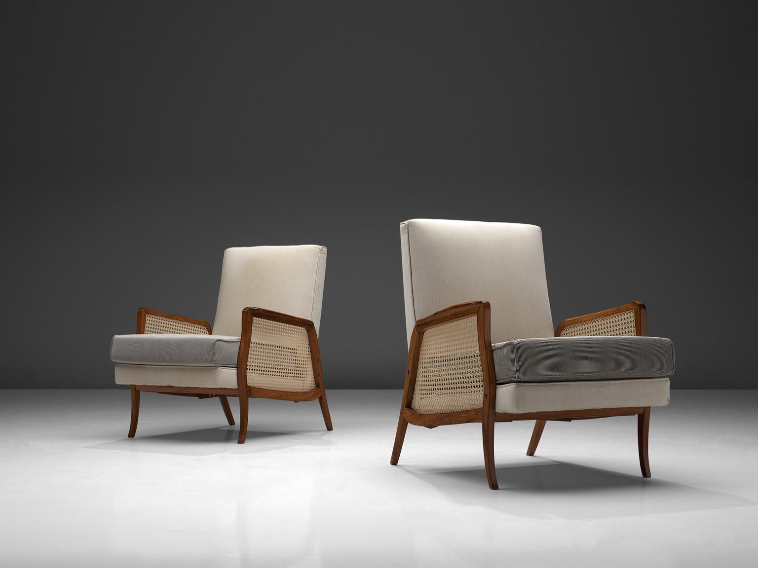 Set of two armchairs, caviuna, cane and grey fabric, Brazil, 1960s

This Brazilian set of lounge chairs were made in the 1960s. The chairs have an elegant character, yet comfortable due to the soft cushions both in the backrest and seat. The