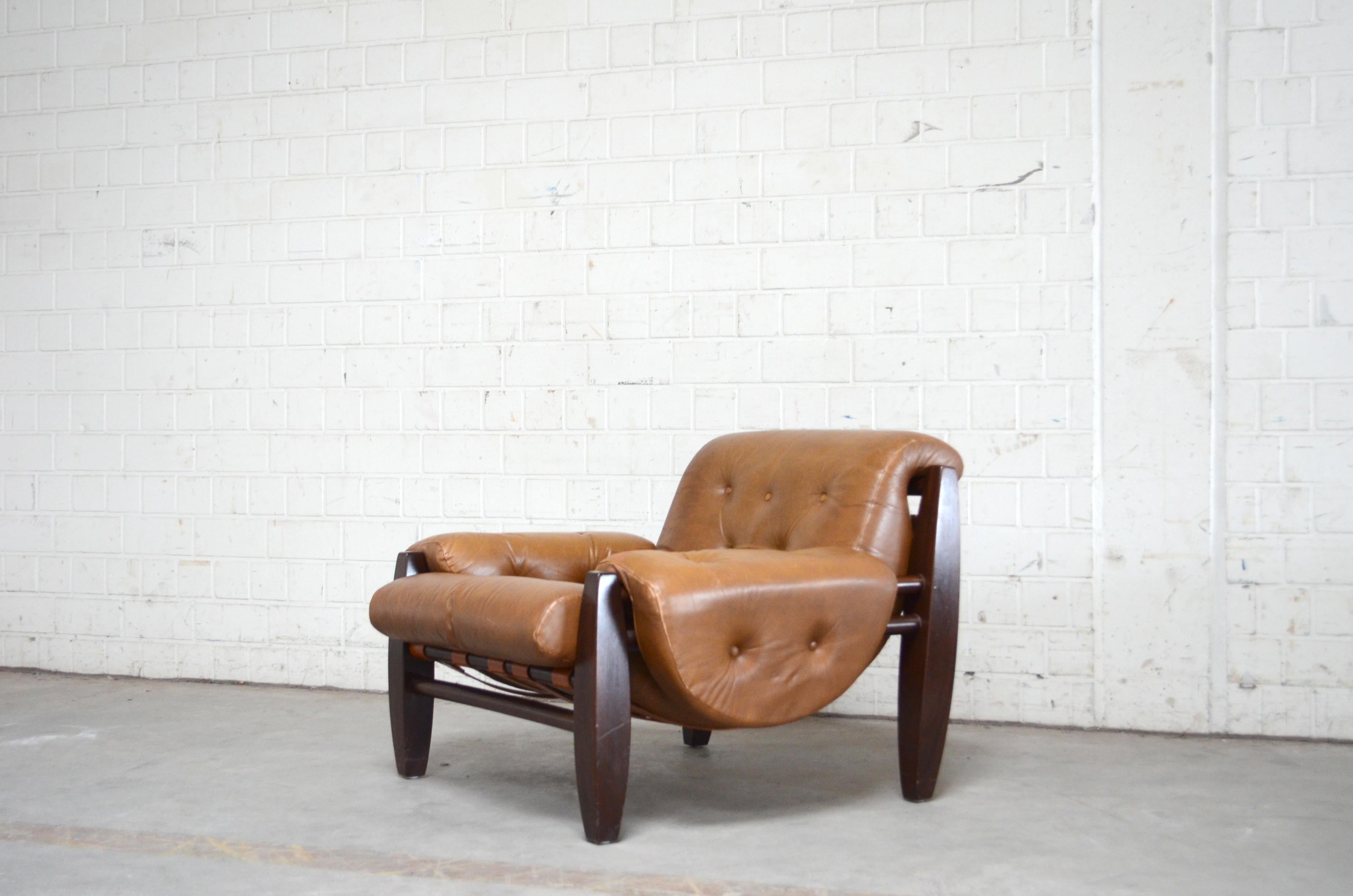 This armchair is from the 1960s. 
It´s made of Pau Ferro wood and cognac leather.
The design has references to Jean Gillon work but the manufacture and designer is unknown.