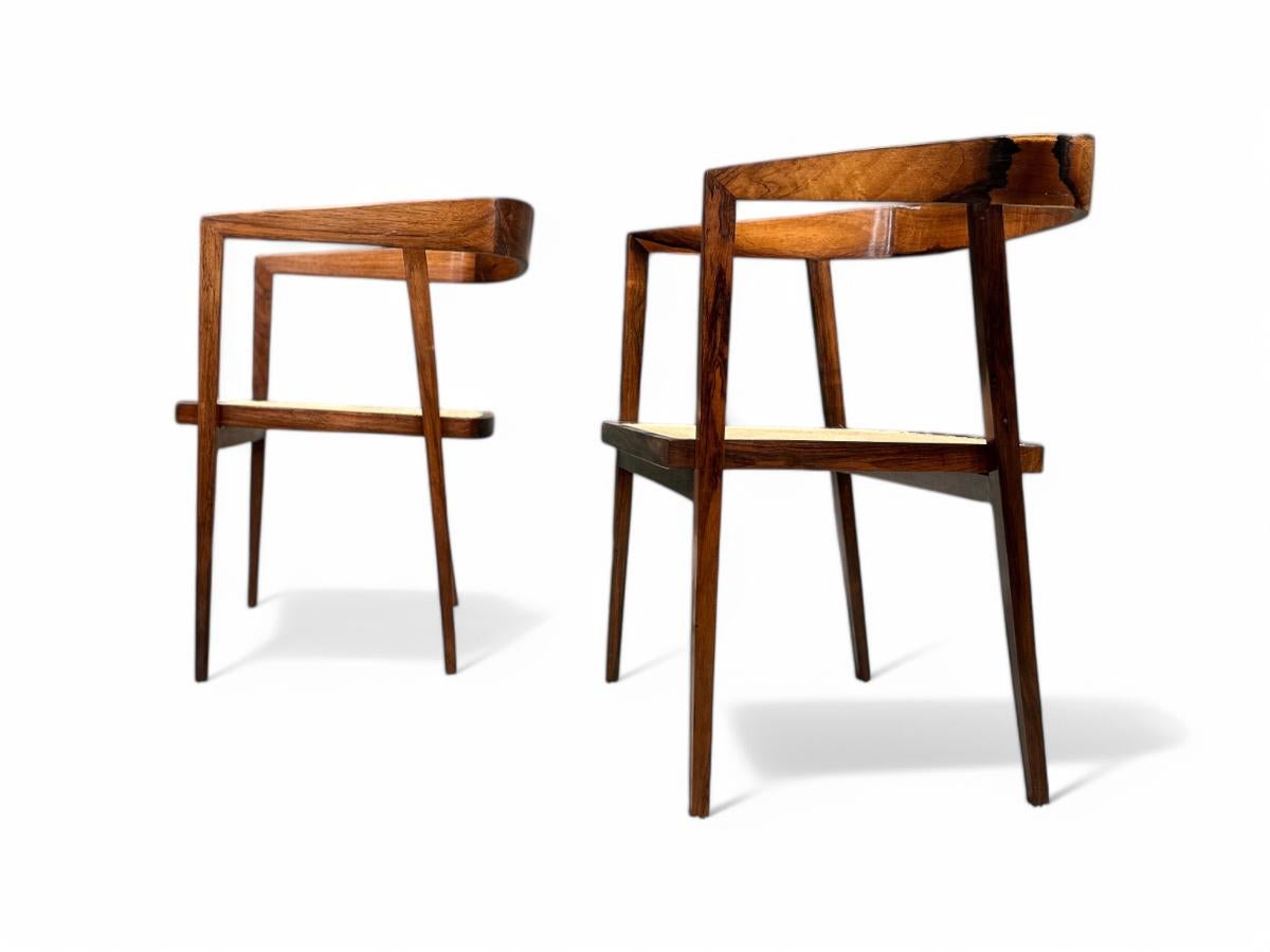Available today, with domestic shipping in the NYC metro area included, this Brazilian pair of armchairs in Rosewood & Caning by Joaquim Tenreiro, c. 1950s, is nothing less than gorgeous! 

These elegant armchairs are made with a Brazilian rosewood