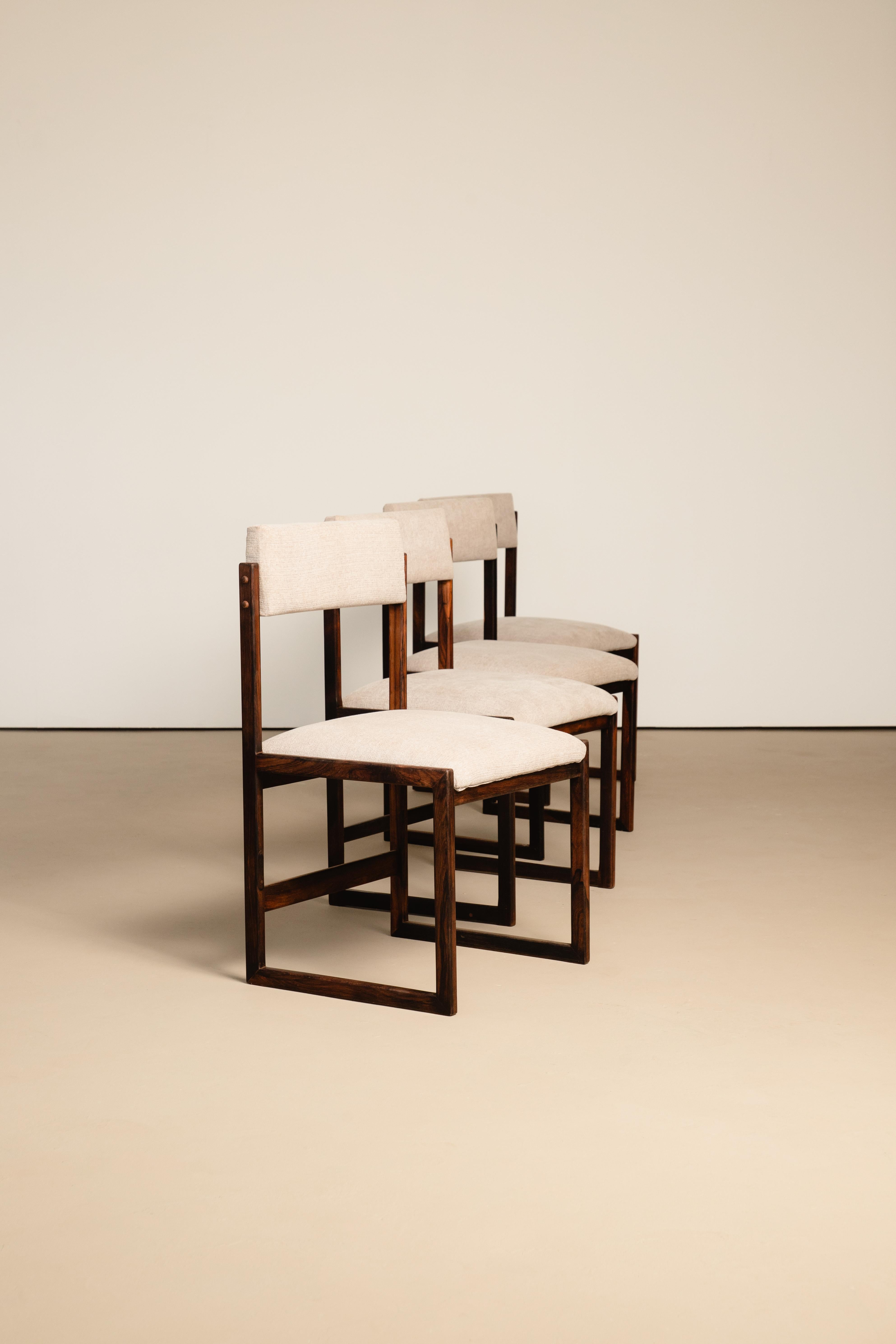 Set of upholstered chairs with solid rosewood structure by Fátima Arquitetura e Interiores (FAI). One of them retains a seal. Created in the 1960's by architects Guilherme Nunes and Sávio Visconti in Rio de Janeiro, Fátima Arquitetura e Interiores