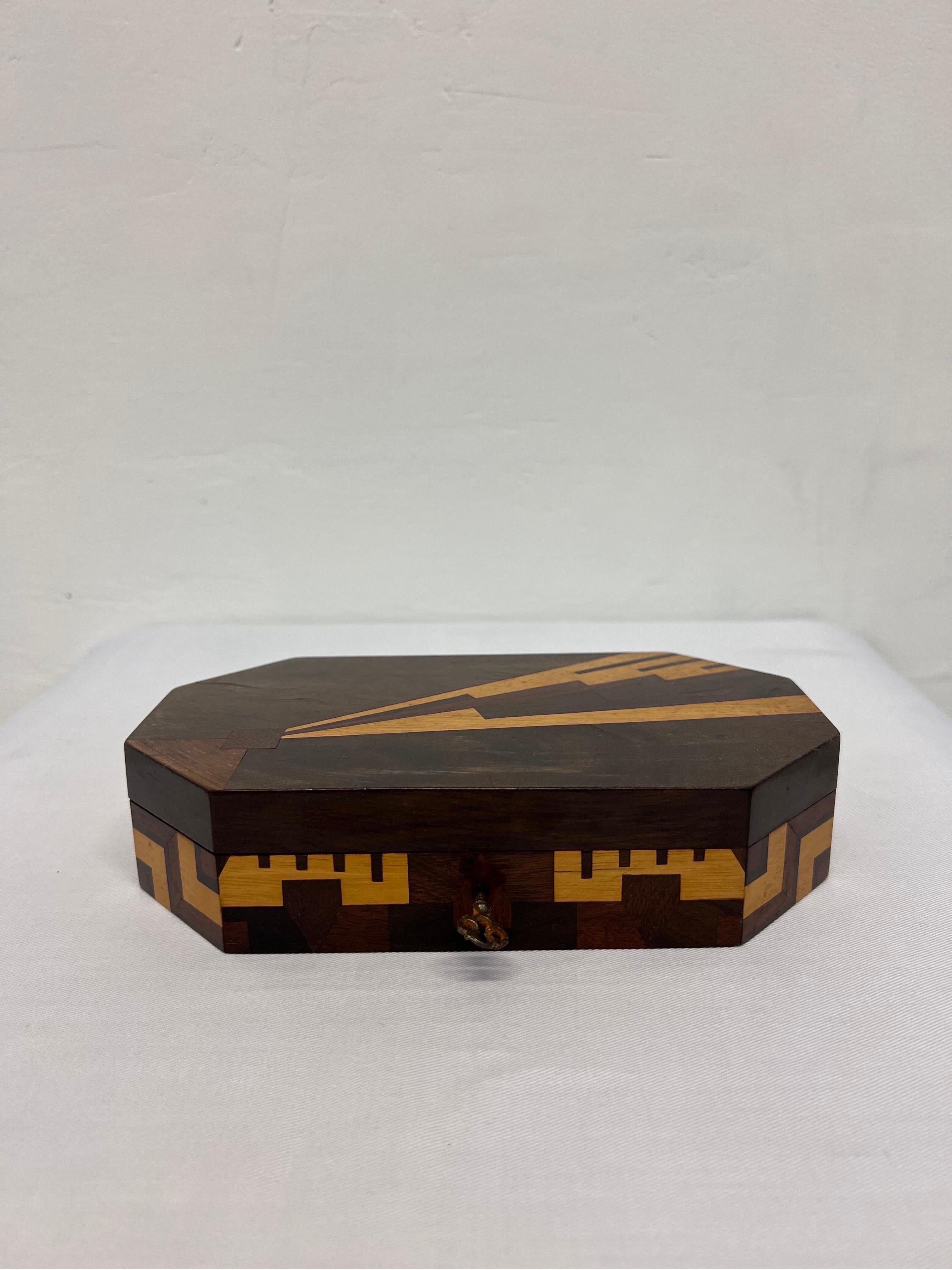 Brazilian Jacaranda jewelry box with geometric marquetry both outside and under the lid. Box retains key and lock is functioning. Brazil, 1960s.