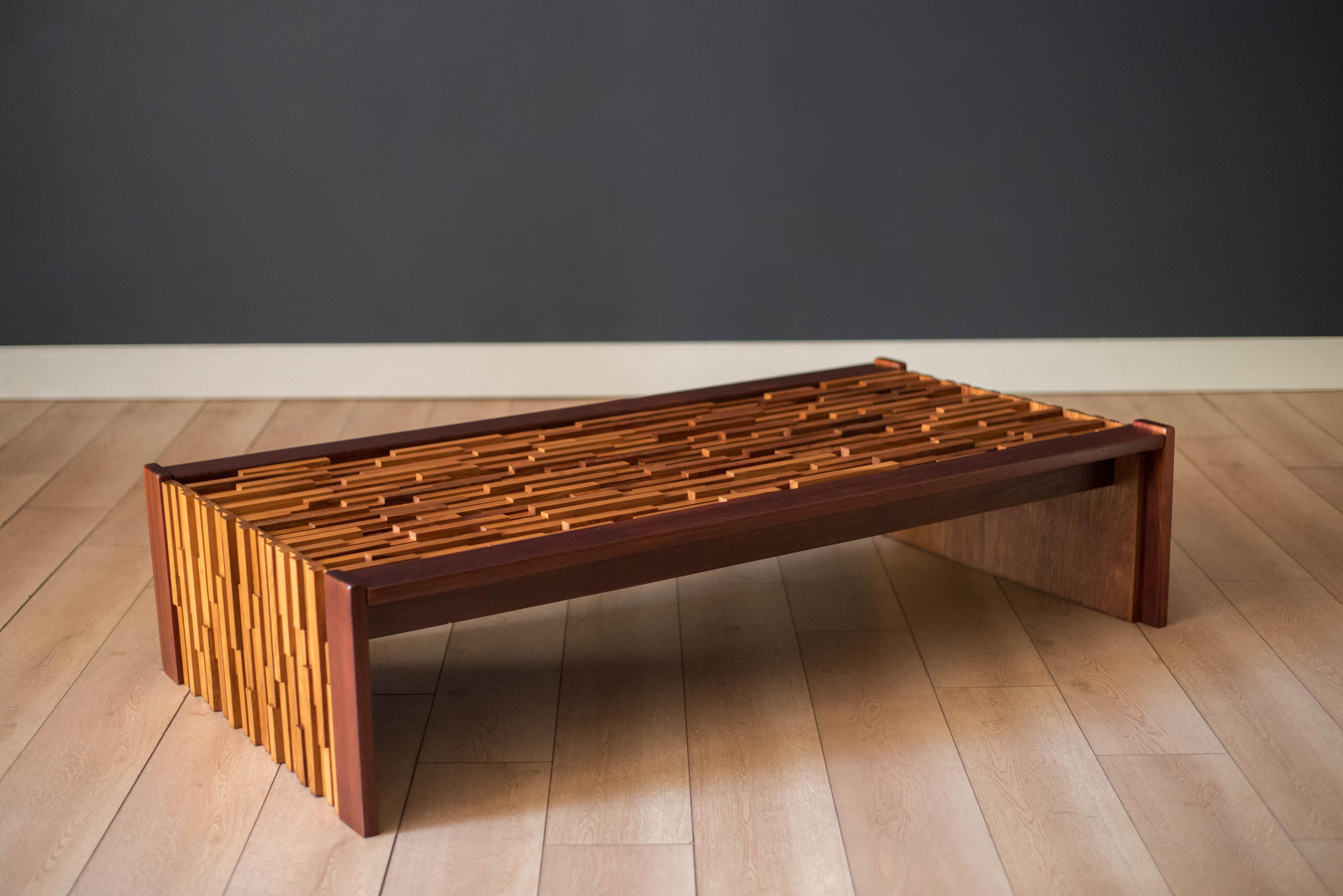 Vintage coffee table designed by Percival Lafer circa 1970's. Features a continuous mixed wood pattern of rosewood, mahogany, jacaranda, and teak with offset varying levels that is sure to make a statement in any space. Includes a protective glass