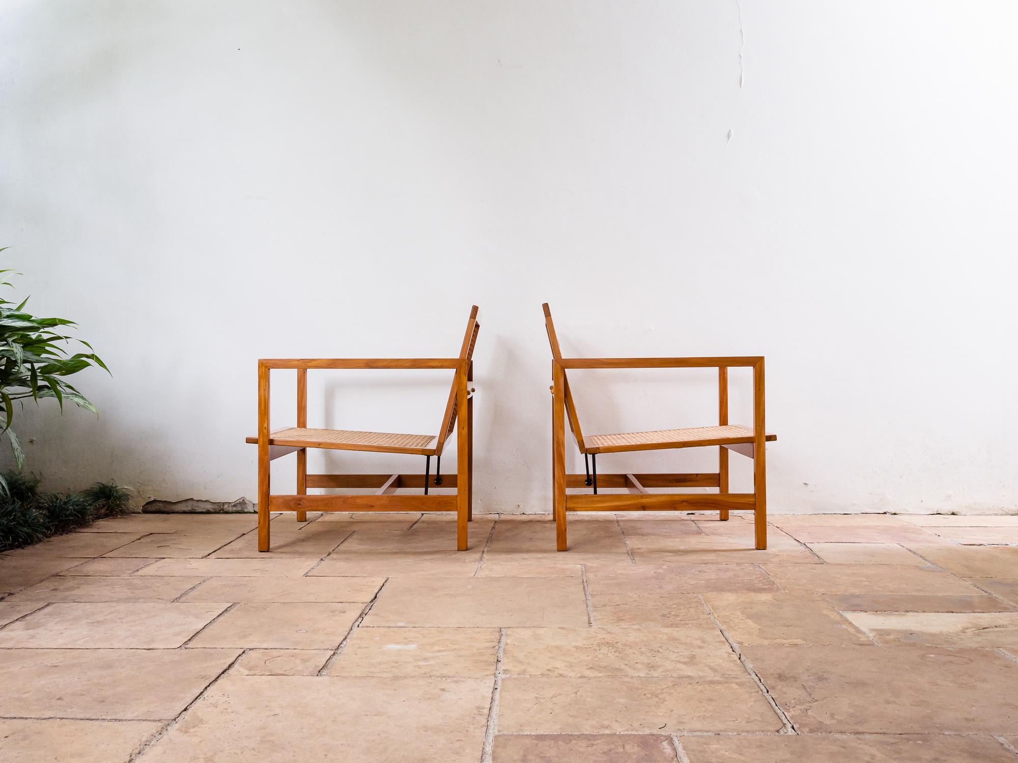 Brazilian Mid-Century Modern chairs from circa 1968, unknown author.
This beautiful pair of lounge chairs is produced in 'Peroba do Campo' hardwood, and feature Italian natural cane seats and backrests. The overall square shape is contrasted by the