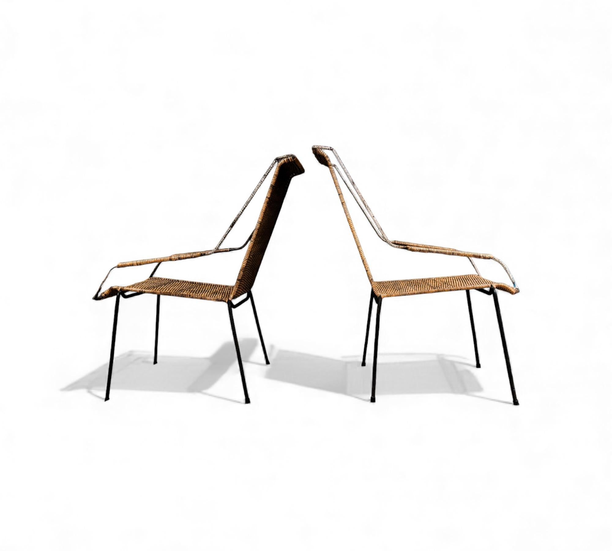 These armchairs feature an iron structure with four legs, a tall backrest, a curved seat, and wide armrests with caning. The cane and iron are in their original condition and complement each other beautifully. Designed in the fifties as outdoor