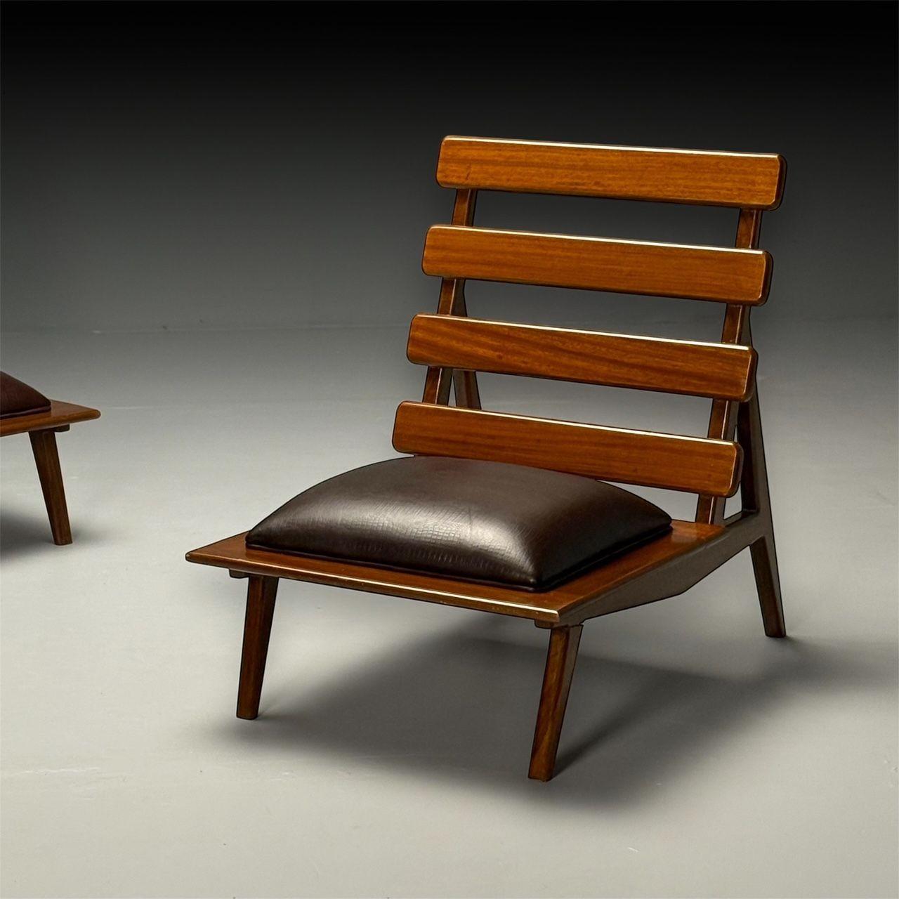 Sergio Rodrigues Style, Brazilian Mid-Century Modern, Sculptural Lounge or Slipper Chairs, Mahogany, Leather

This pair of Brazilian Mid-Century Modern sculptural lounge chairs, inspired by the work of Sergio Rodrigues, features an elegant