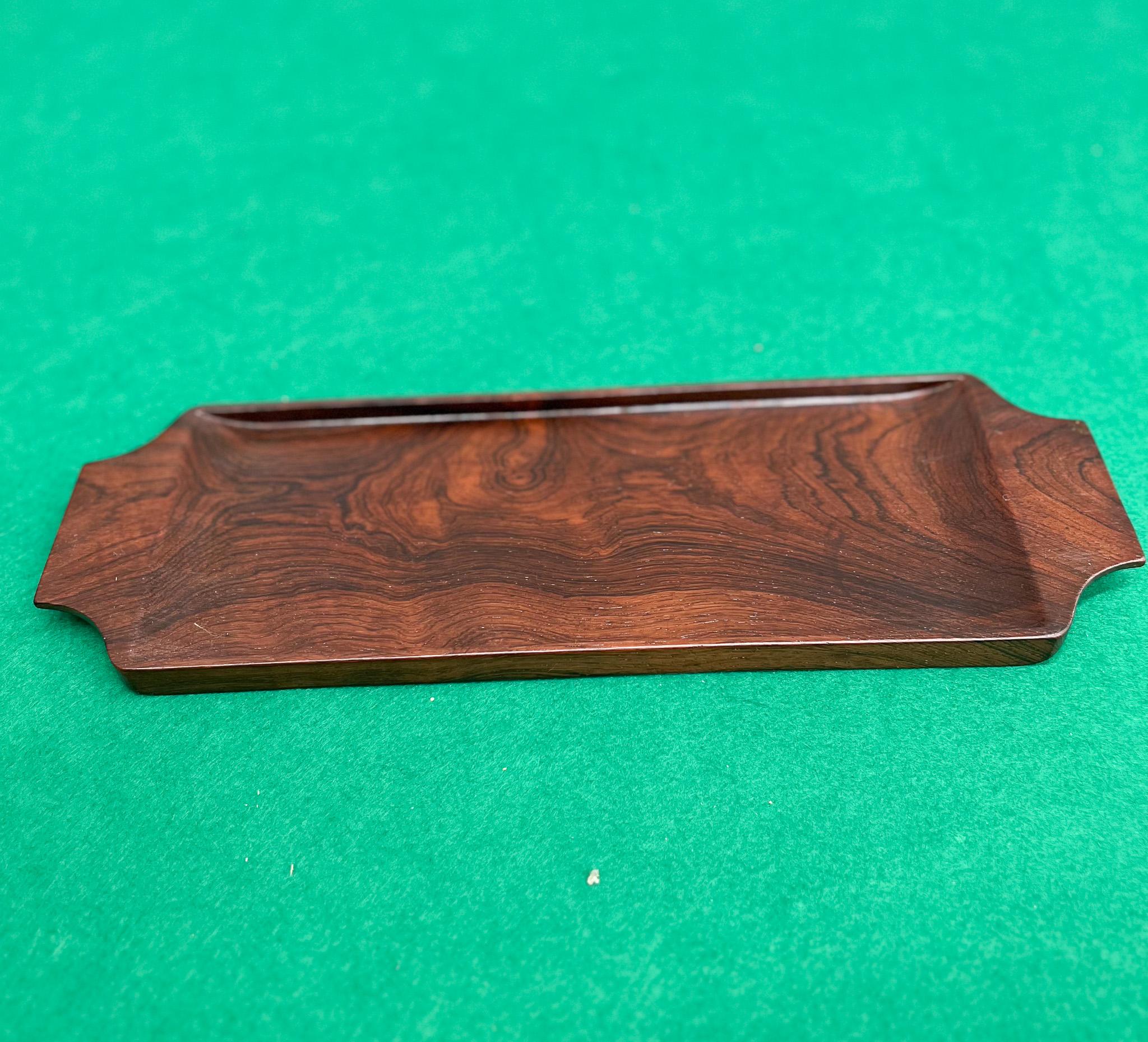Available today, this Brazilian mid-century modern serving platter is absolutely stunning.  This platter is handcrafted with Brazilian rosewood (also known as jacaranda) and features clean lines with elegant curves. The wood has a deep, dark, and