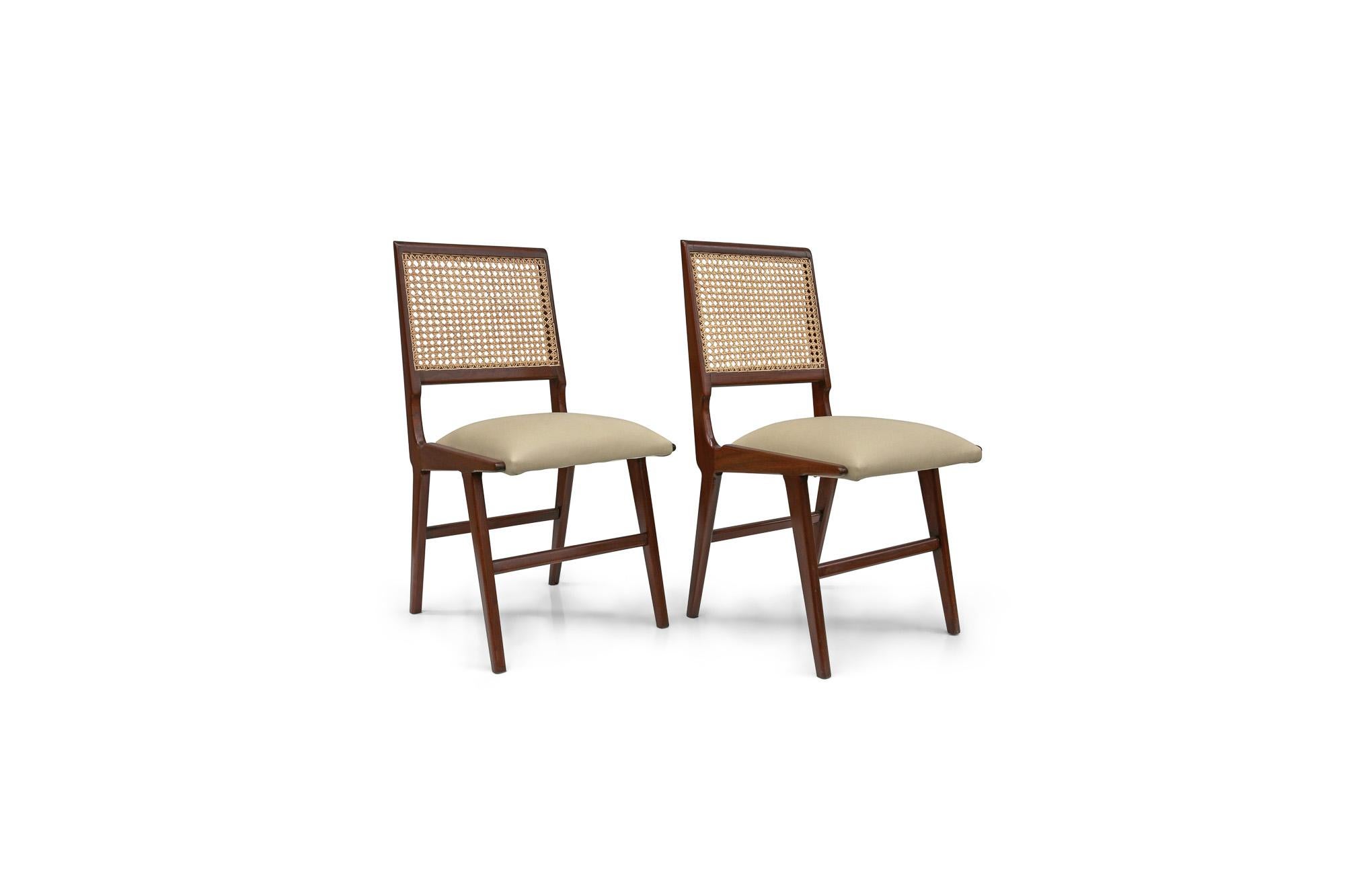 Available today, with domestic shipping in the NYC metro area included, this Brazilian Mid-Century Set of Two Chairs in Hardwood and Leather by Forma 1950s is nothing less than gorgeous! This pair of chairs features a hardwood frame and upholstered