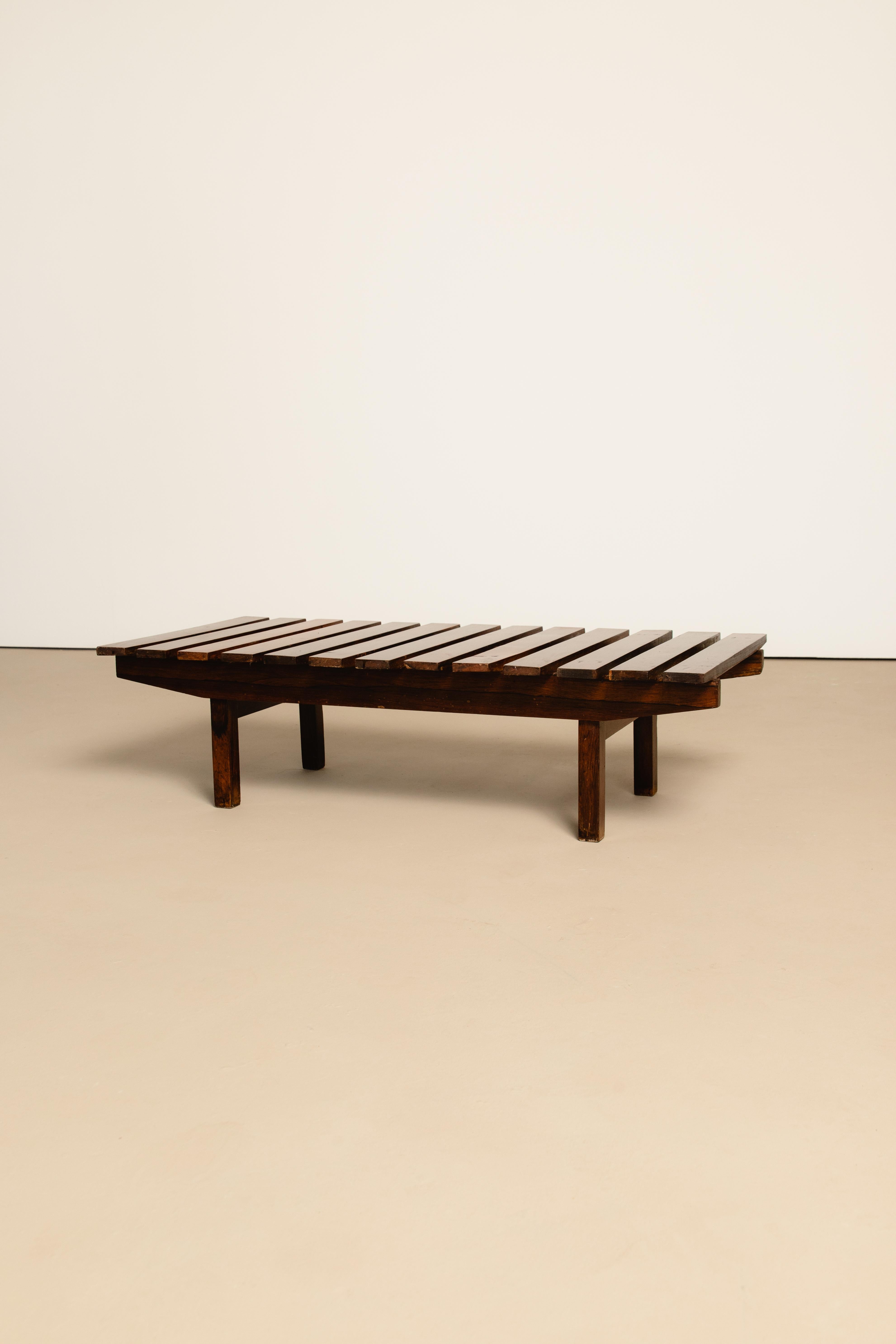 Brazilian midcentury bench in solid rosewood by unknown author. Can be used as a center table.