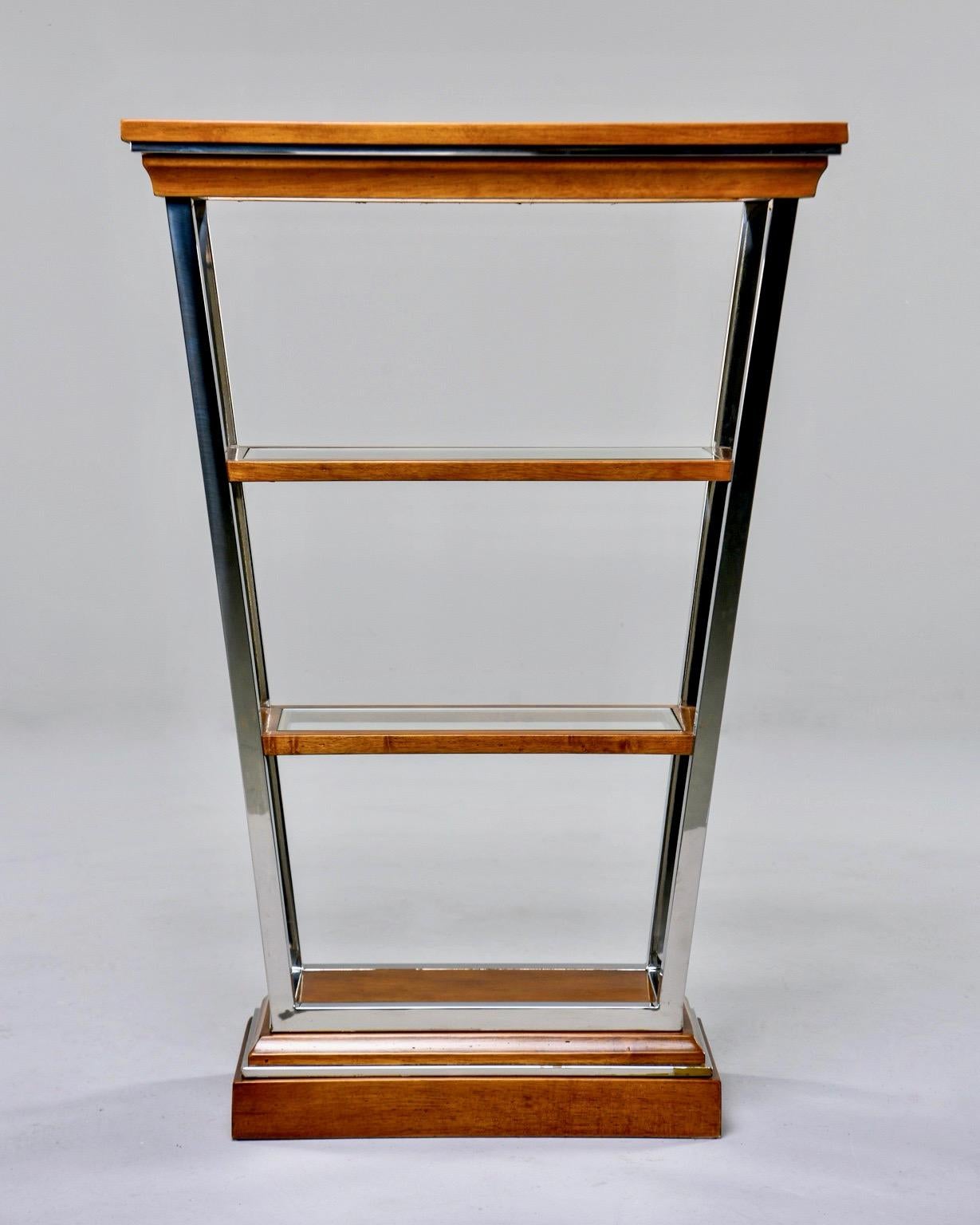Brazilian étagère features four shelves in V-Form with chrome trim and glass insert shelves, circa 1970s. Unknown maker. Very good vintage condition.