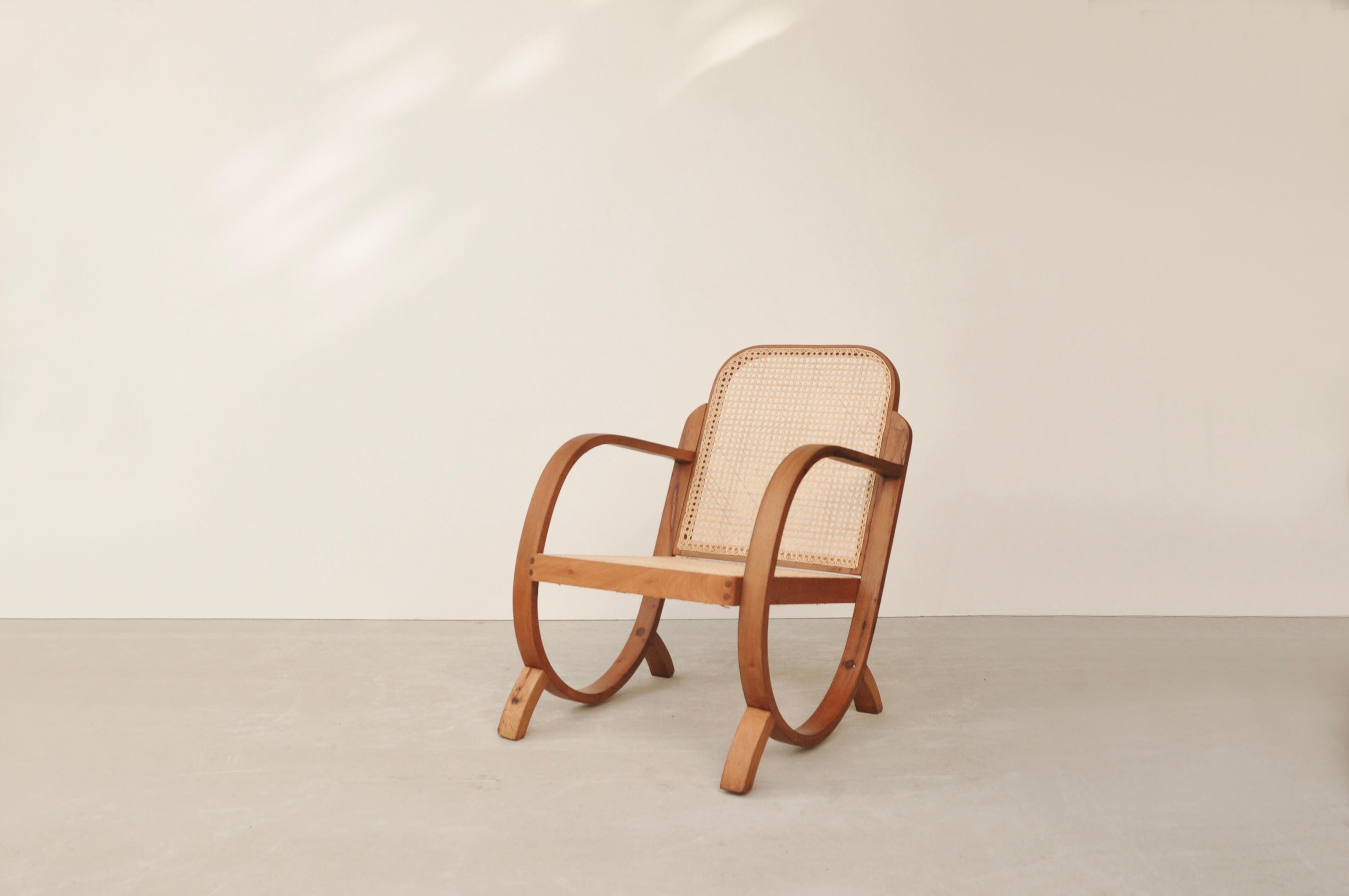 Armchair with structure in bent solid wood and seat and backrest in natural cane designed and produced by Móveis Gerdau in the 1960s in Brazil. It has been completely restored with new wood finish and new natural plaited cane. Móveis Gerdau was a