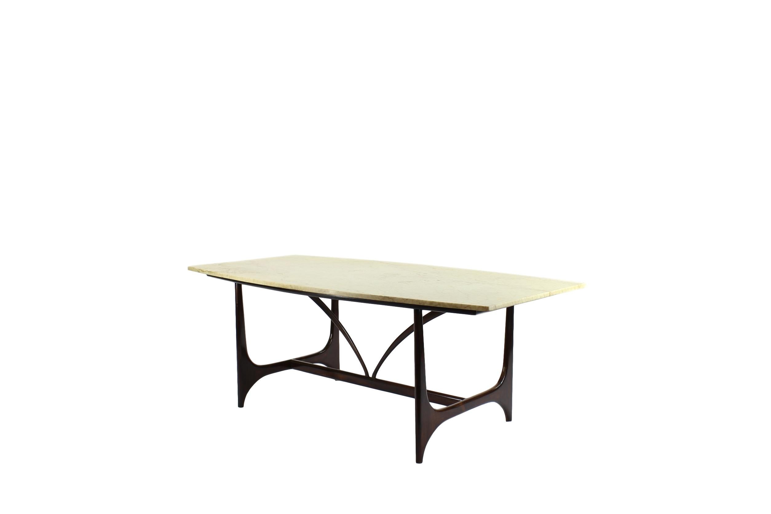 Spectacular dining table in rosewood and marble on top designed as a tribute of Brasilia shapes.

Referred to often as the “father” of Brazilian modernism, furniture designer Joaquim Tenreiro, who was born in Portugal and moved to Rio de Janeiro in