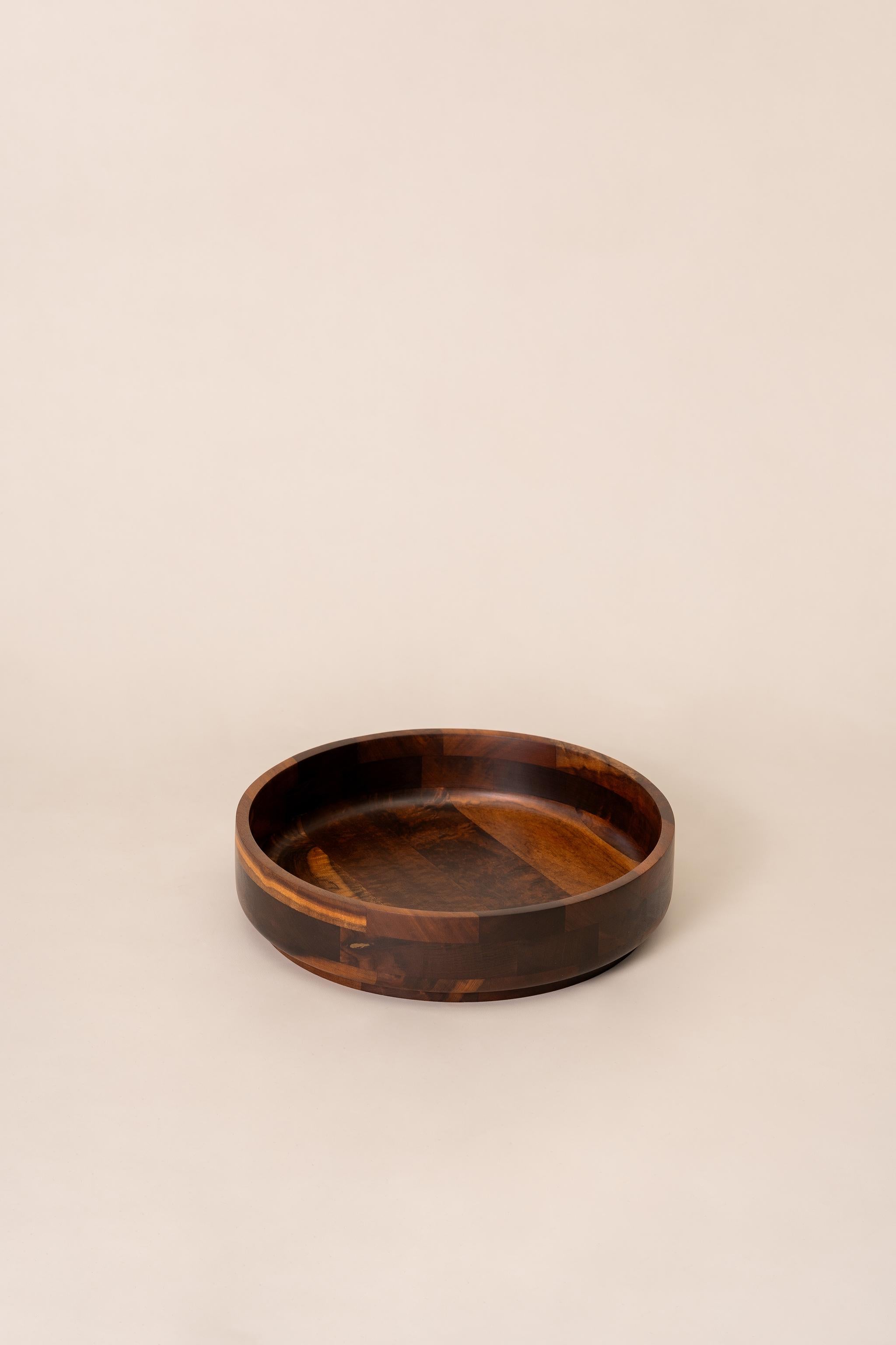 Large and stunning bowl carved in noble wood that can also be used as a centerpiece, designer by Jean Dobré for Tropic-Art. It keeps the manufacturer's mark on the bottom. 

Tropic-Art was a big company that produced utilitarian serving pieces with