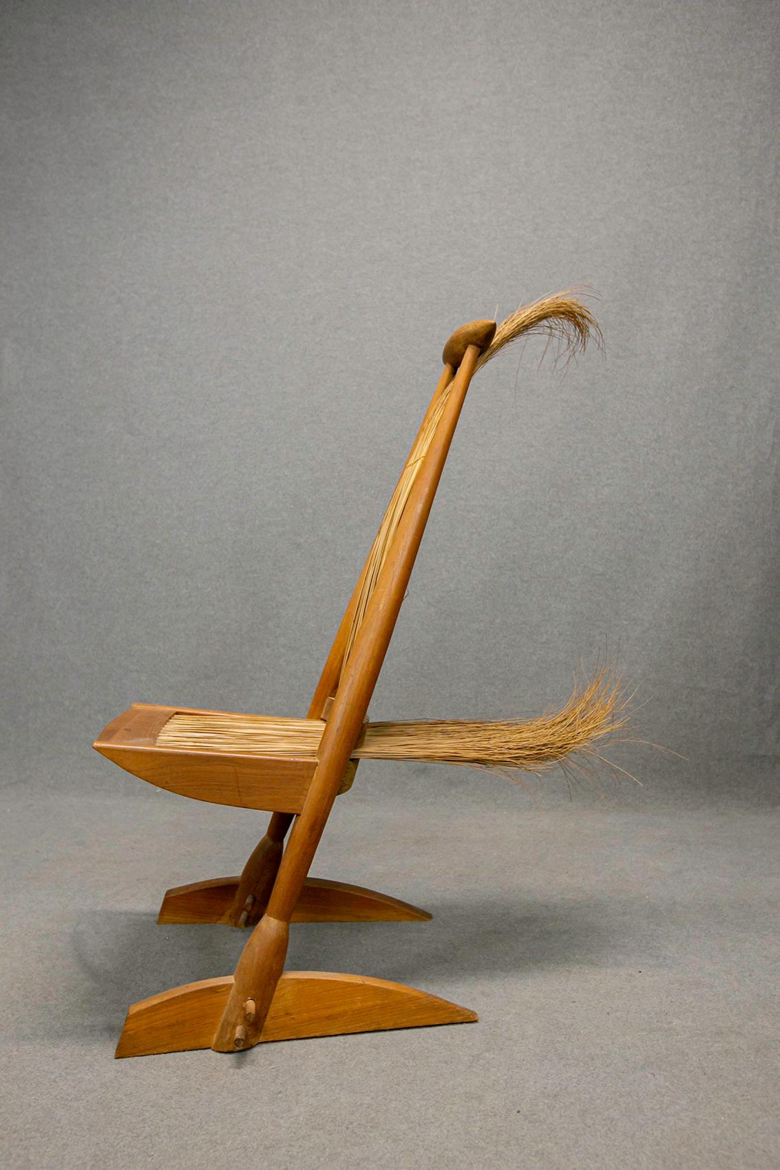 Rare armchair in cherrywood and essaywood. Brazilian manufacture, 1950s. The structure of the armchair is in cherrywood while the seat and backrest are in essaywood. The peculiarity of the armchair is its broom shape, which seems to represent the