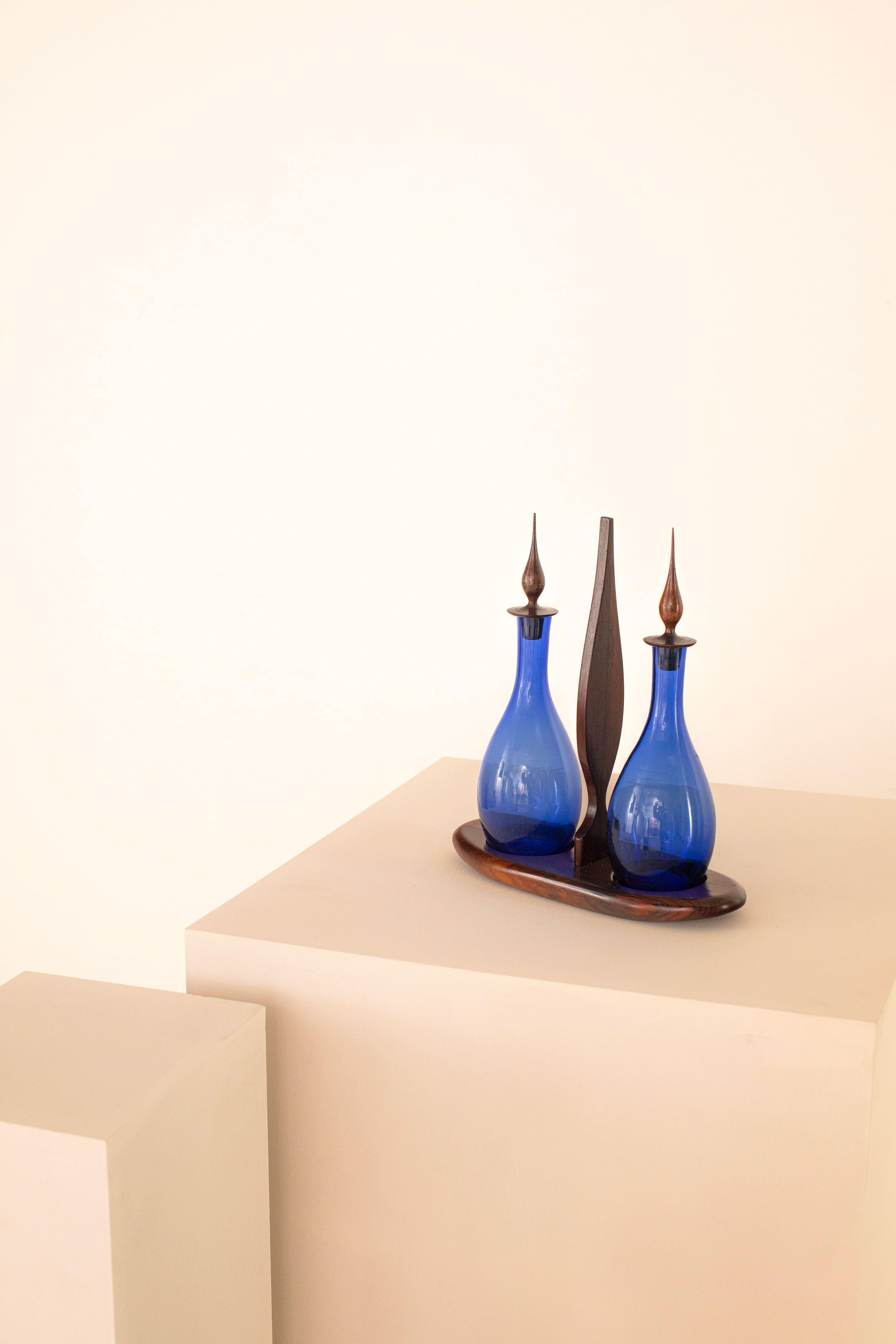 Stunning blue glass double cruet with lids and support in Brazilian rosewood from Bahia. Preserves the seal of 