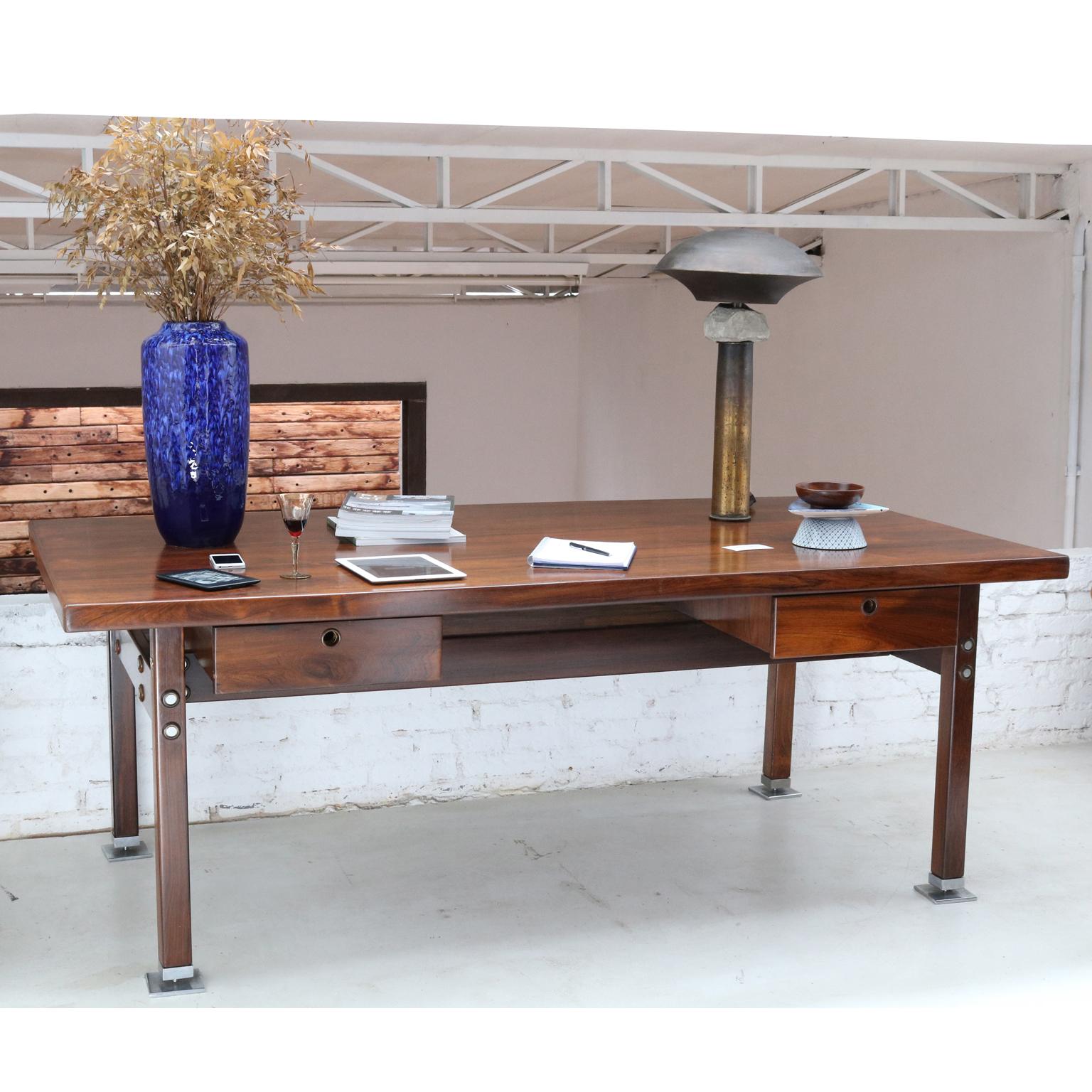 Brazilian midcentury desk table designed by Sergio Rodrigues, 1960s.
Materials: jacaranda wood and chromed metal.
Structure in solid hardwood, plywood covered in jacaranda wood and chrome plated brass trim. Created for the government ministries in