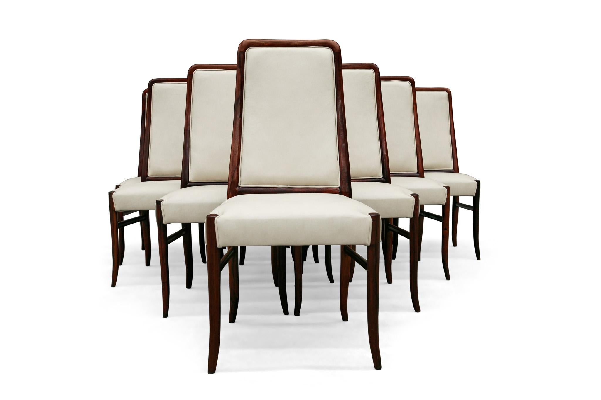 Available today, this magnificent Mid-Century Modern ten dining chair set n hardwood & beige leather by Joaquim Tenreiro in the sixties is the find of the year!

Each chair features a solid Rosewood structure upholstered in beige leather. The legs