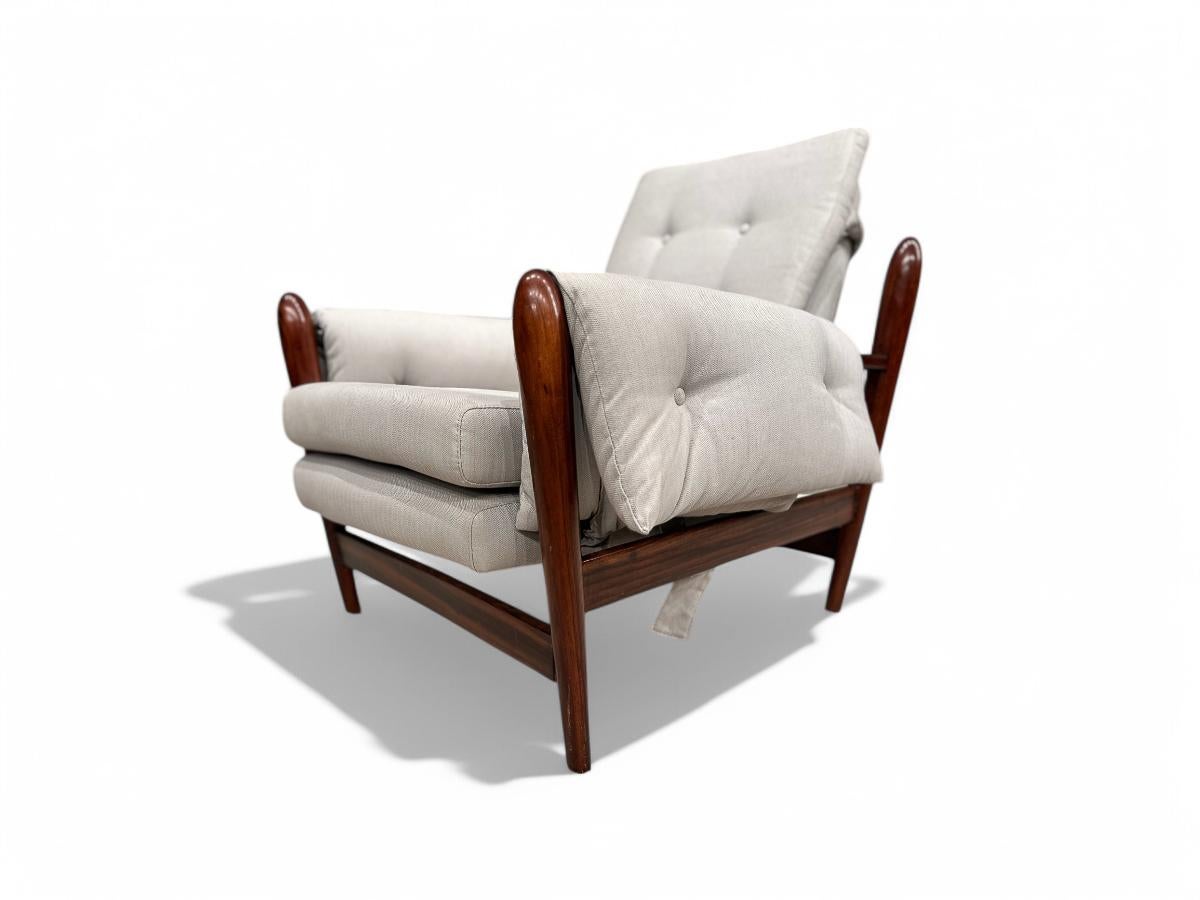 Available right now, this gorgeous Mid Century Modern armchair has a solid Brazilian Rosewood base, known as Jacaranda and upholstery in soft Grey velvet. The wood is of the finest quality showcasing colorful veins. The armchair has a tall backrest