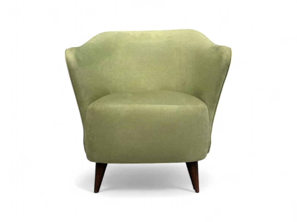 This armchair, attributed to Joaquim Tenreiro, features a hardwood structure with four pointed legs and upholstery in super-smooth, comfortable light green Ultrasuede. The model is named 