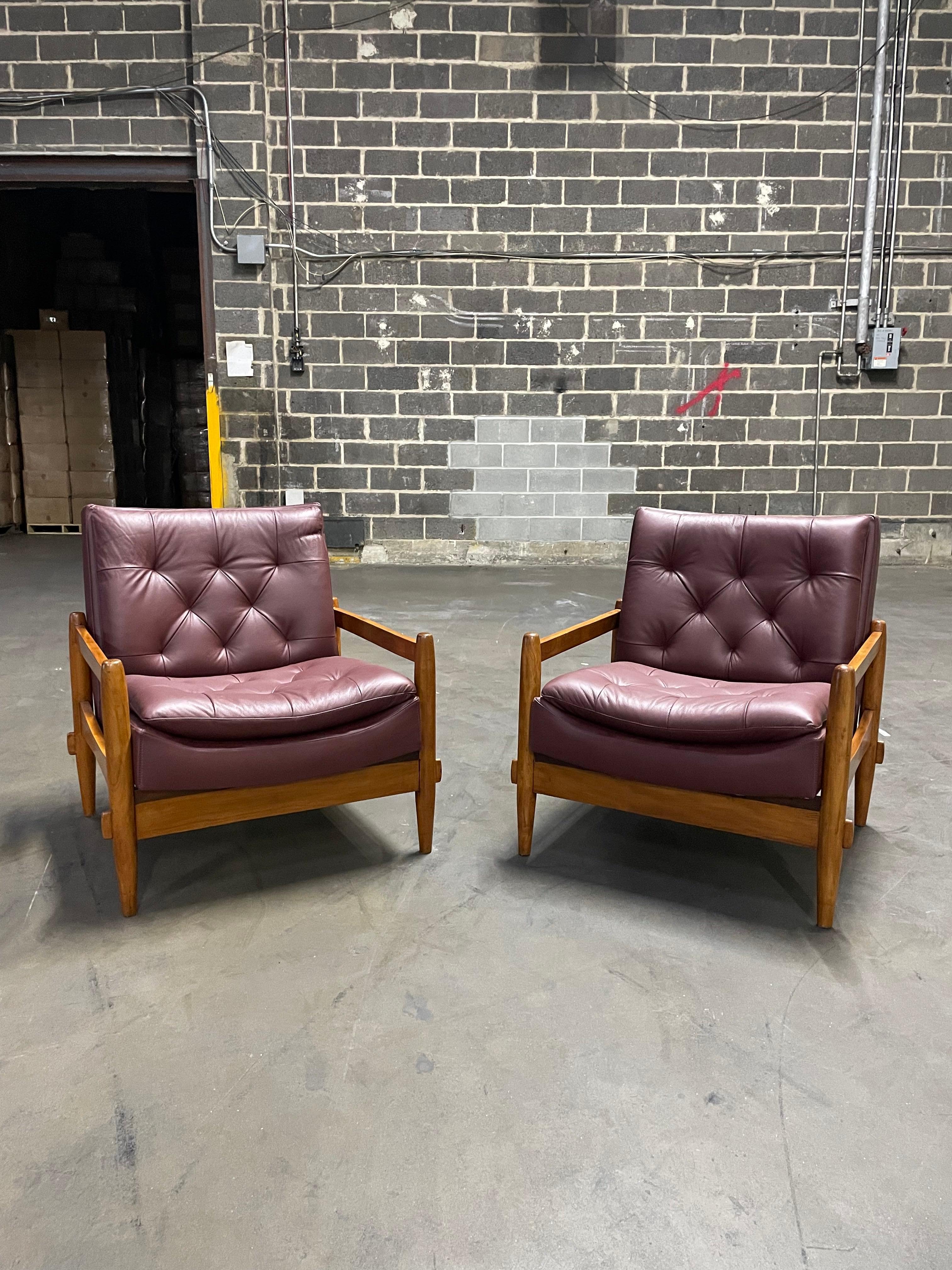 Available now, this super comfortable and visually striking pair of armchairs are made of a solid hardwood frame and purple leather upholstery with buttons in the backrest.

These armchairs have been re-upholstered by some of the best upholsterers