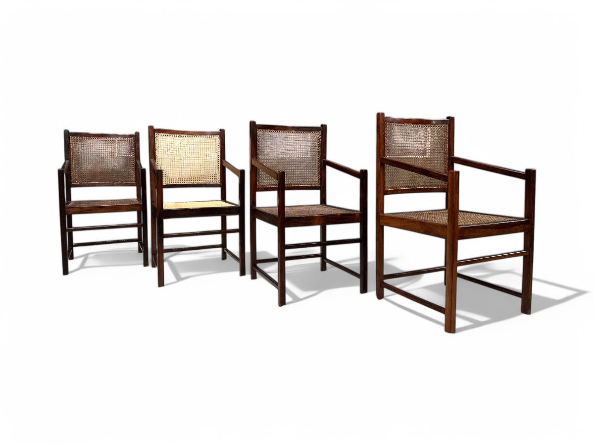 Available today, these four Brazilian Modern Armchairs in Rosewood & Handwoven Cane, are exquisite.

The armchairs are made of solid Brazilian Rosewood and handwoven cane in the seat and back. One of the chairs has new cane and the rest the original