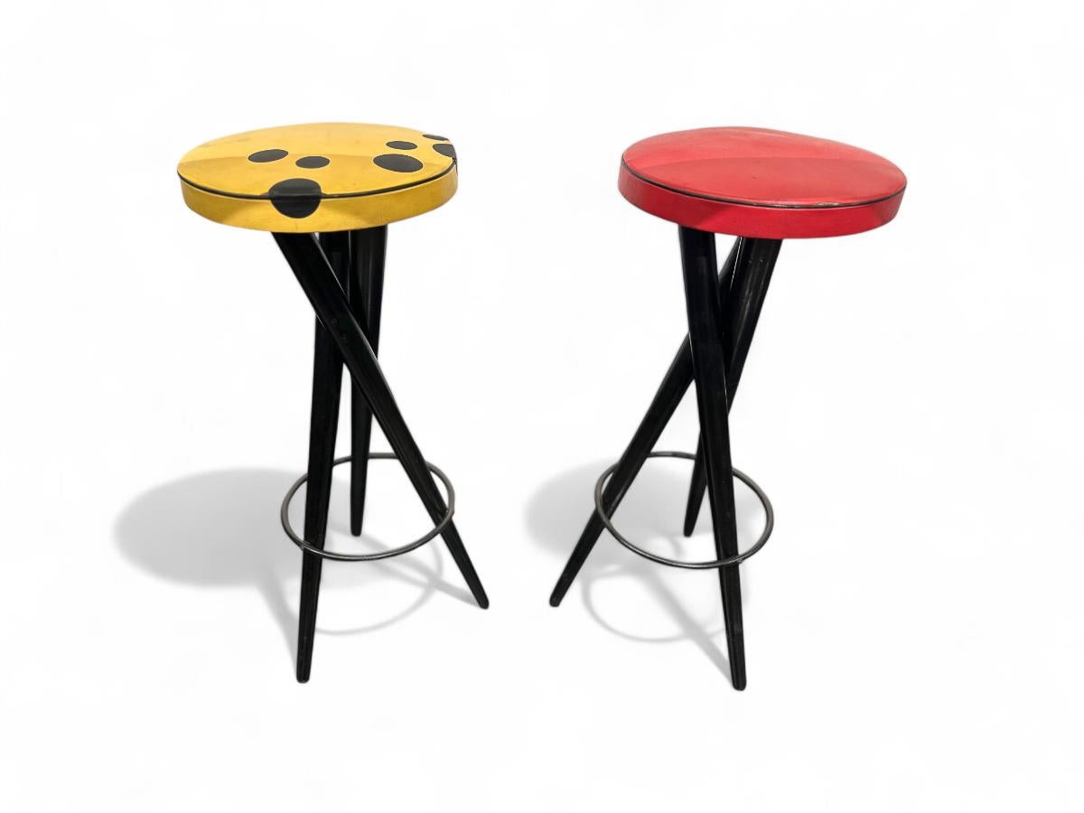 Available today, these Brazilian modern bar stools in Hardwood & red & yellow Leather s, Brazil, 1950s are awesome!

These funky and stylized stools feature three intertwined ebonized wood legs with faux leather seats in vibrant red and yellow