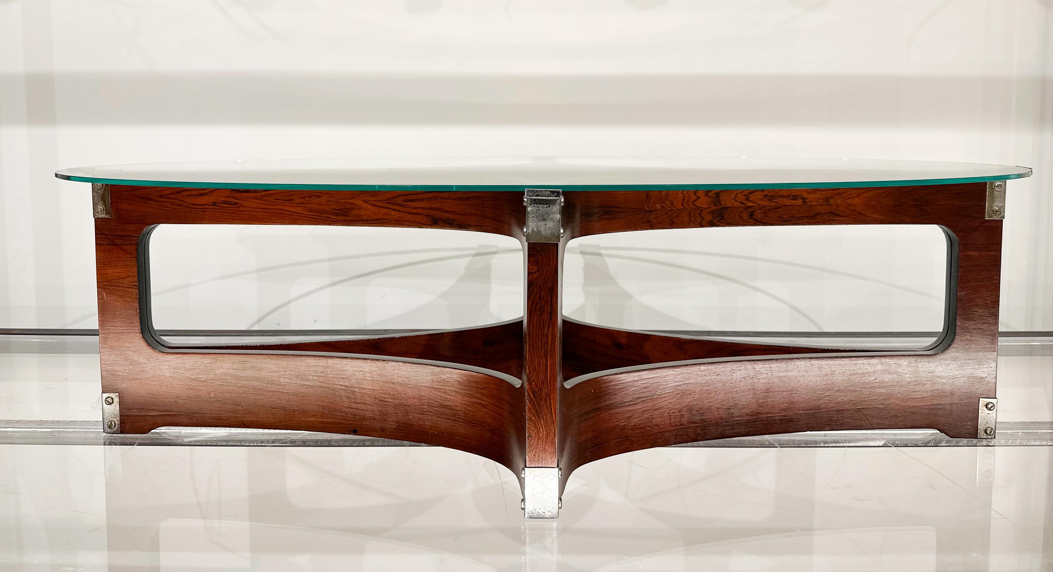 Available today with domestic shipping included, this Brazilian Modern Coffee Table in Bent Wood & Glass, Novo Rumo made in Brazil during the  1960s is nothing less than spectacular!

Made with bent rosewood this coffee table exudes timeless beauty.