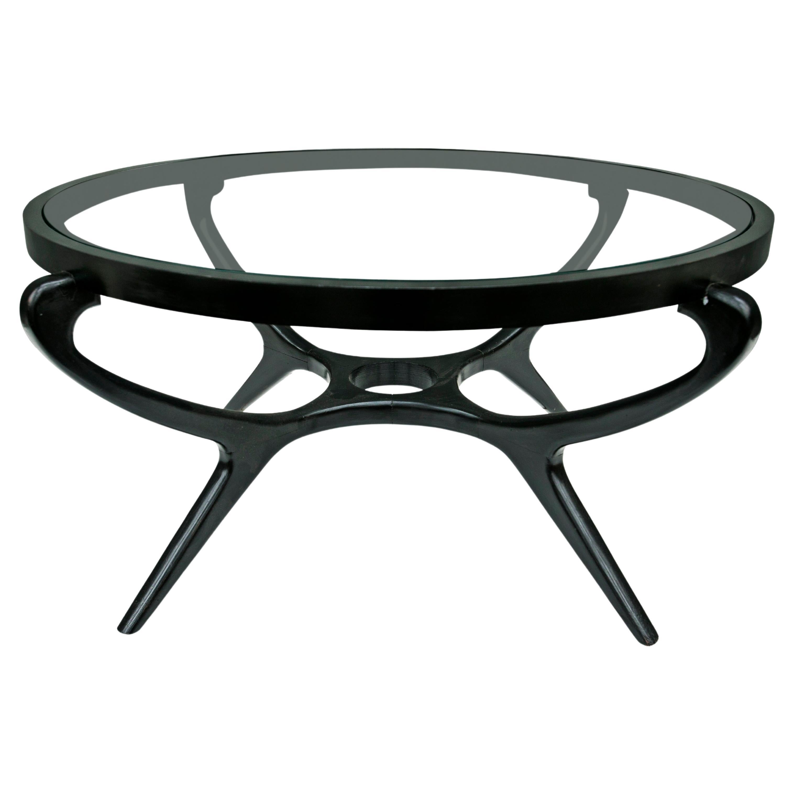 Available today, this Brazilian Modern coffee table in hardwood with Ebony finish and glass by Giuseppe Scapinelli, 1950s is gorgeous!

The coffee table is entirely made in hardwood with ebony finish and features four curved legs, a middle level