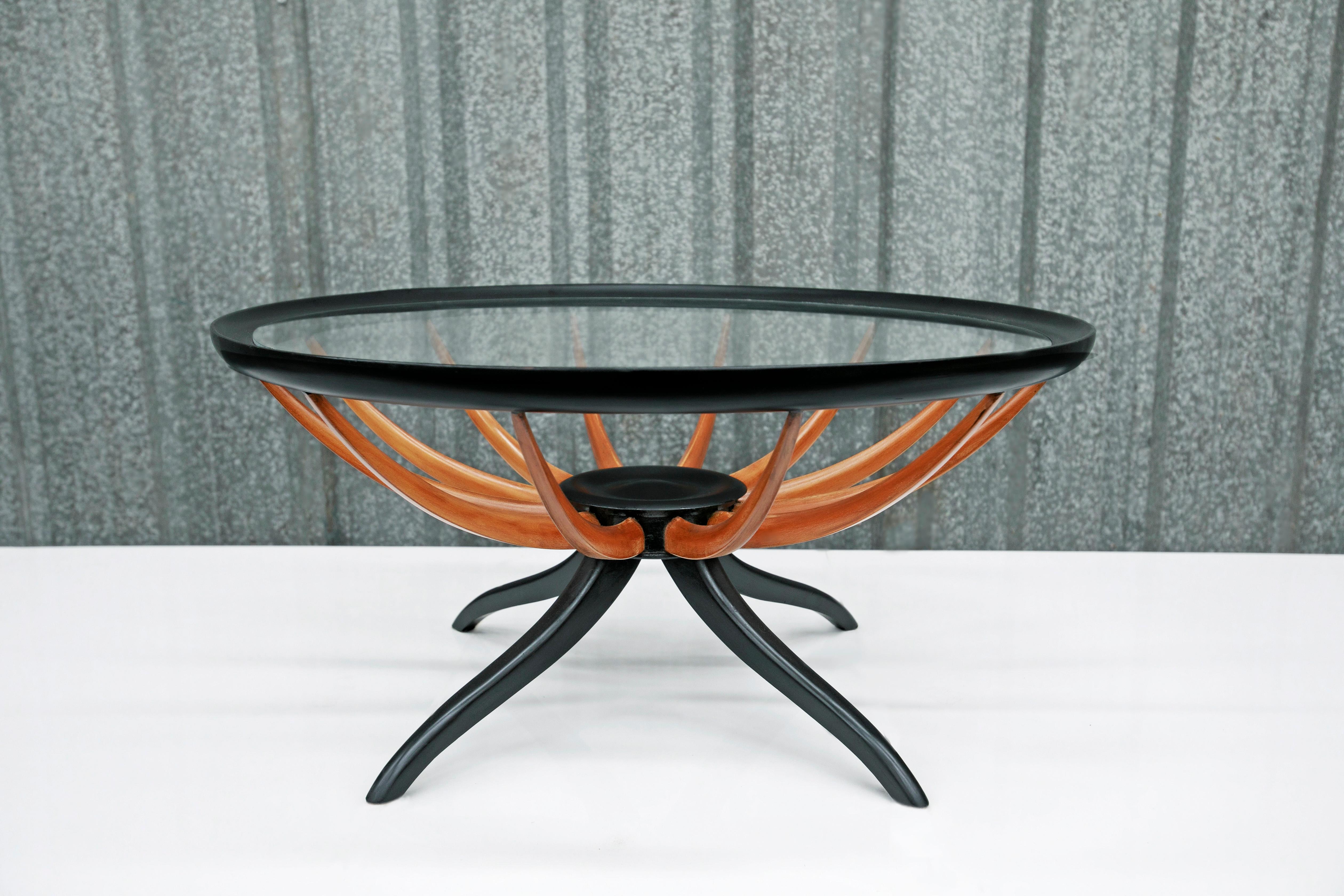 Available today, this iconic Mid-Century Modern coffee table made in hardwood & glass by Giuseppe Scapinelli in the fifties is fabulous. 

The coffee table is entirely made in Pau Marfim hardwood, and features four delicate legs and a top made in