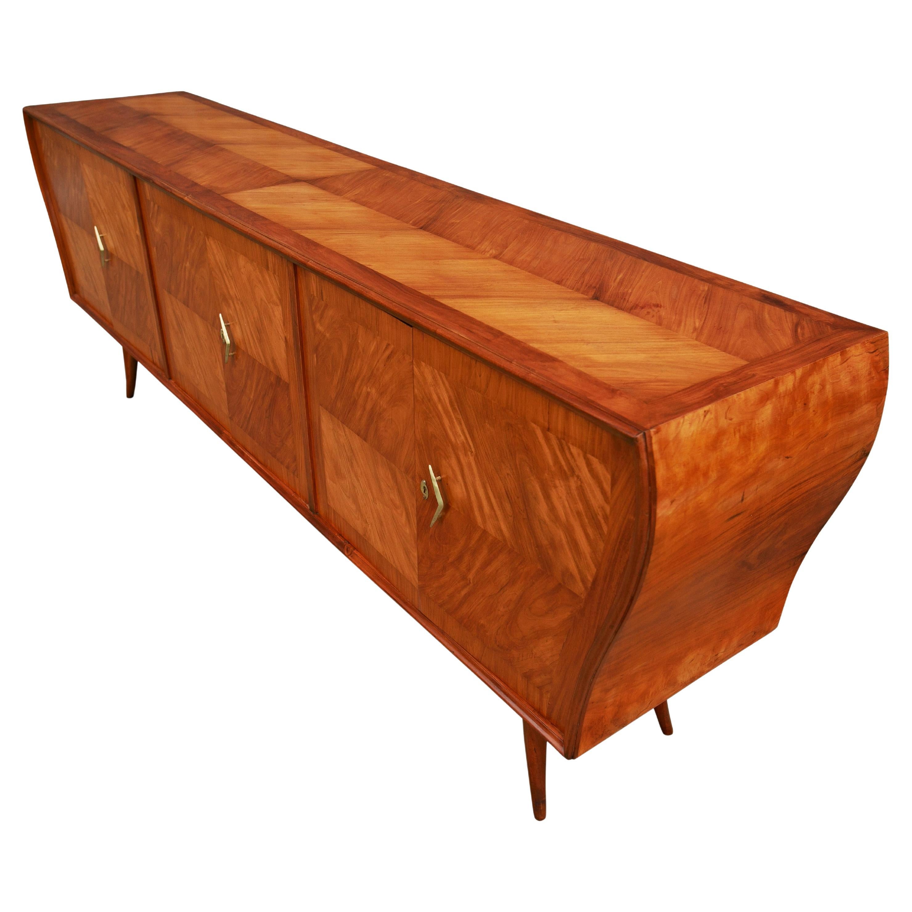 Available today, this one-of-a-kind Mid-Century Modern Credenza in Caviuna Hardwood designed by Ando in the fifties is the FIND of the year and is nothing less than spectacular.

The credenza is made of solid Caviuna wood and features four curved