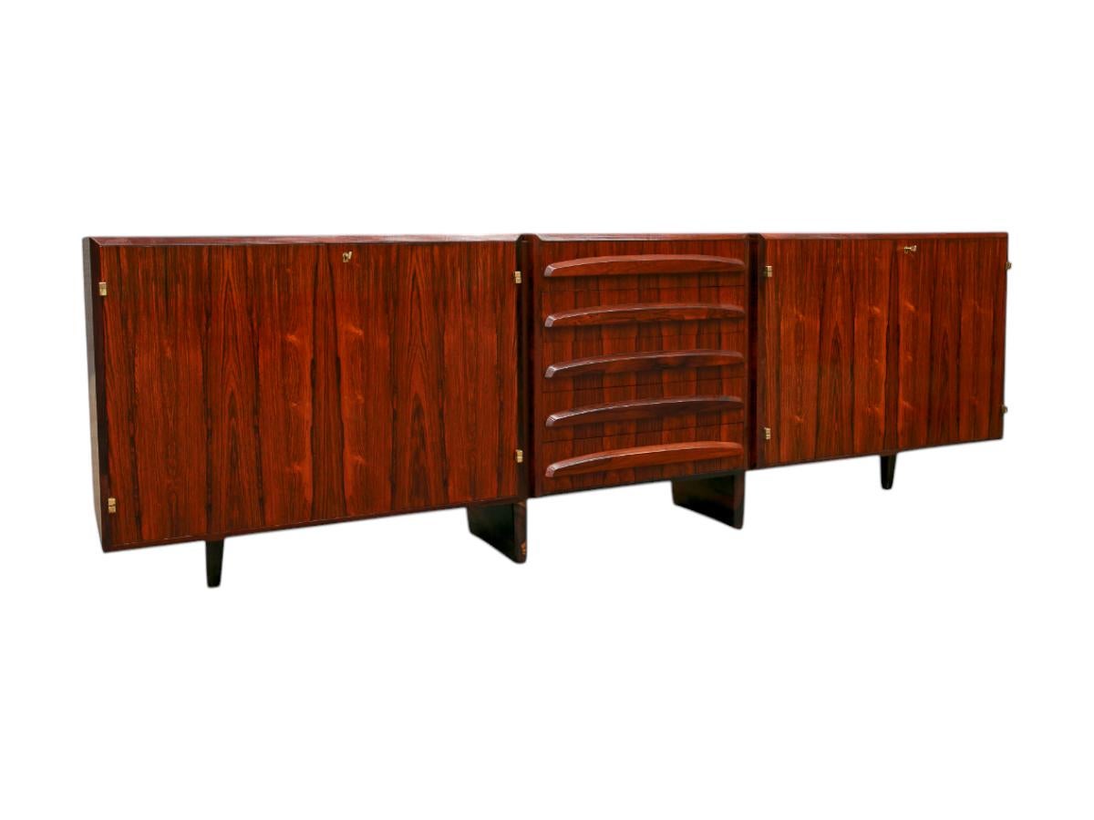 Available today, this Mid-Century Modern Credenza in Hardwood with Brass finishes designed by Jean Gillon in the sixties in Brazil is the FIND of the year.

The credenza has a rectangular structure made of Brazilian Rosewood, known as Jacaranda,
