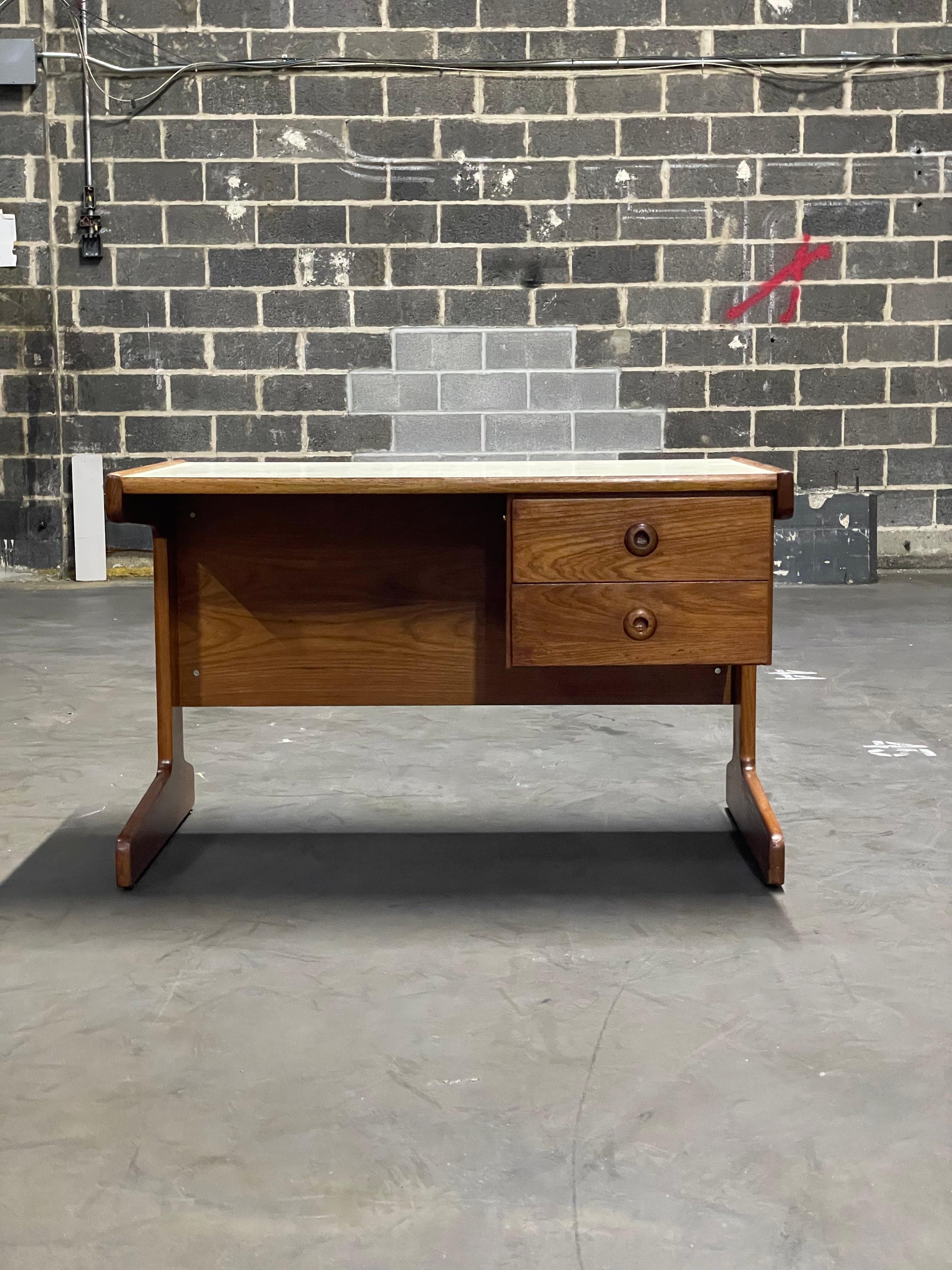 Available now, this Mid-Century Modern Desk designed by Geraldo de Barros for Hobjeto is is gorgeous!
 
The desk is entirely made in Cerejera wood and features two floating drawers and white Formica top. The wood has been refinished and besides