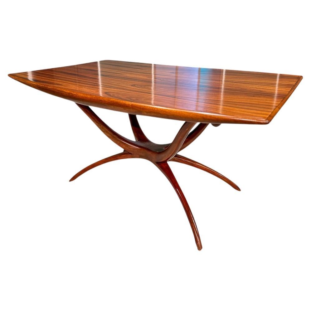 Available today, this Brazilian Modern Dining Table with Sculpted Base designed by Giuseppe Scapinelli is nothing less than spectacular. 

This midcentury modern beauty is made of solid Caviuna wood, a favorite hardwood for designers like Giuseppe