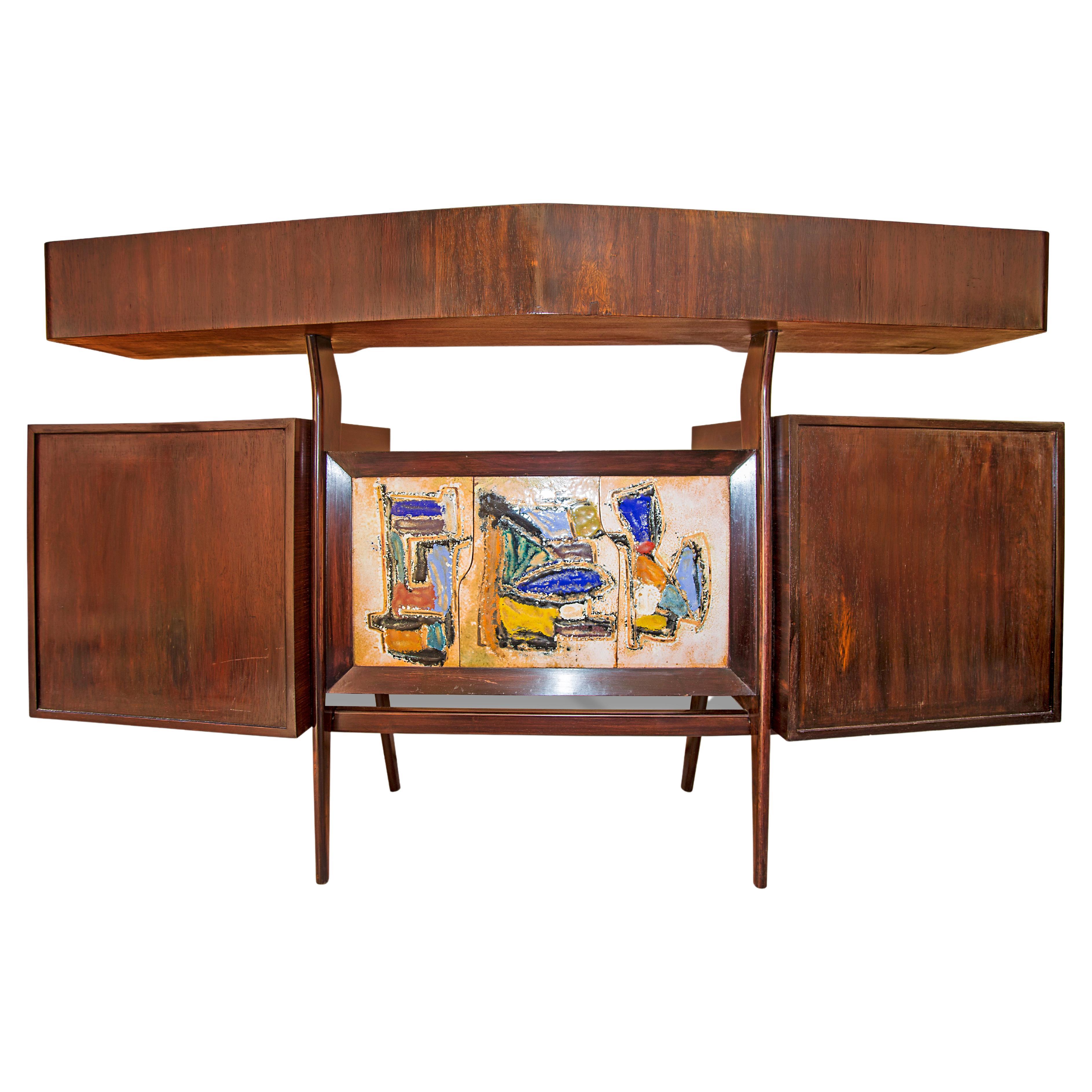Available today, this magnificent Mid-Century Modern, hand painted bar made in Brazilian Rosewood, known as Jacaranda, by Giuseppe Scapinelli in the 1950s is truly a masterpiece!

The bar is made in Rosewood and consists of two cabinets, three