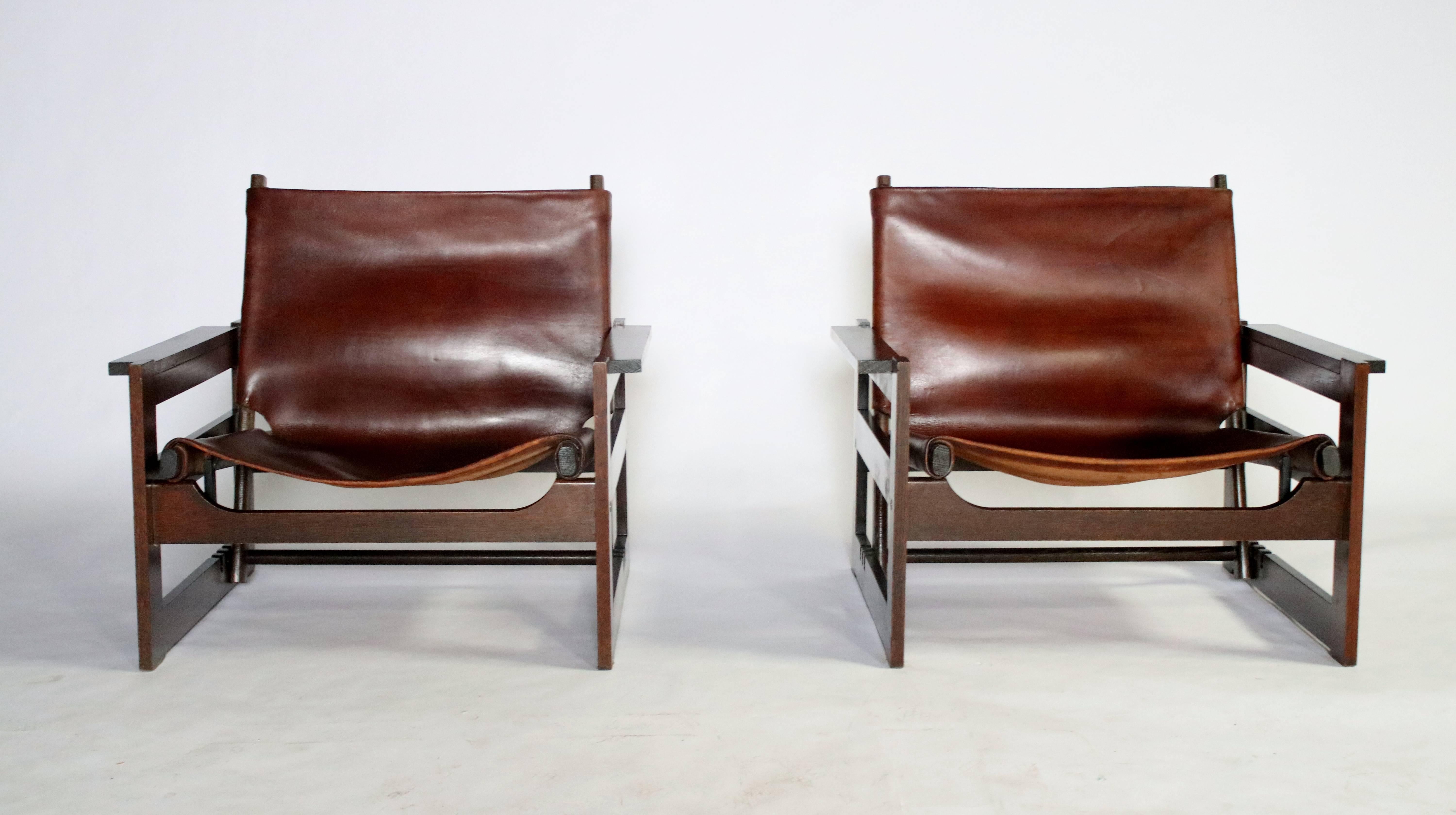 Brazilian modern removable and adjustable leather sling or hunting chairs insert into a wood cube frame. Adjustable sling can be removed or placed in one of three reclining positions. Unmarked, in the style of Sergio Rodrigues, Michel Arnoult or