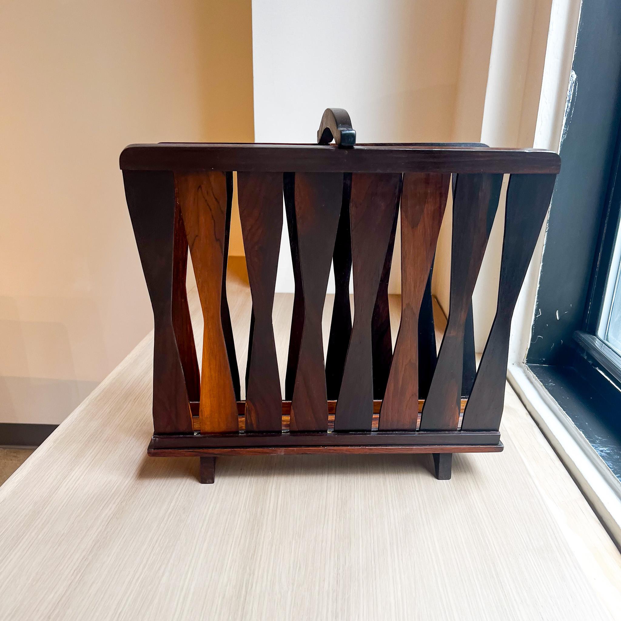 Available today, this Brazilian Modern magazine rack in Jacaranda hardwood is stunning!

This magazine rack is made with Brazilian Rosewood which is also known as Jacaranda hardwood. It is a dark brown color and would be a perfect fit for any