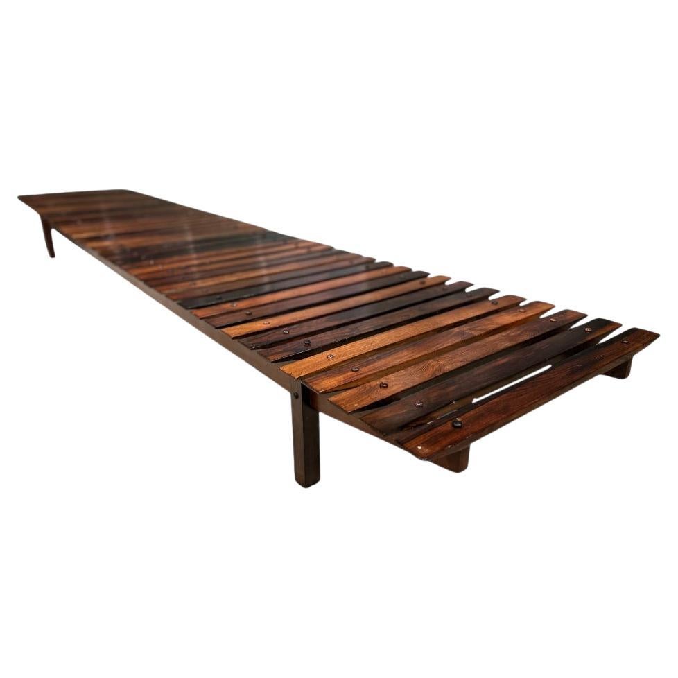 Available now, the Mucki bench, designed by Sergio Rodrigues in 1958 and manufactured by Oca, is nothing less than a stellar piece!

Featuring a low rectangular base with latitudinally positioned slats, the Mucki bench boasts a simple yet elegant