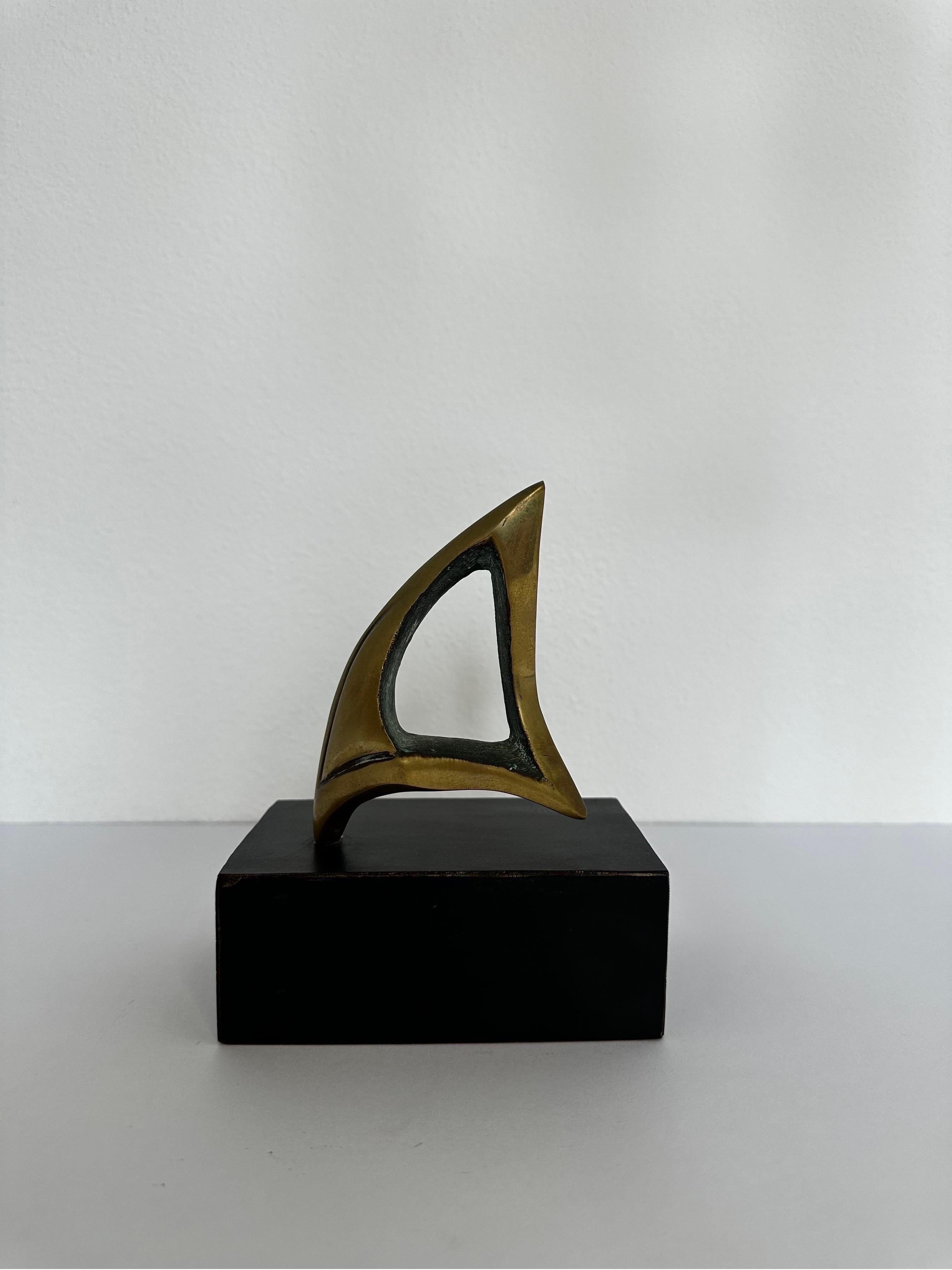 Polished bronze abstract sail sculpture on black painted wood base.  Brazil 1960s.  Signed but artist unknown.
