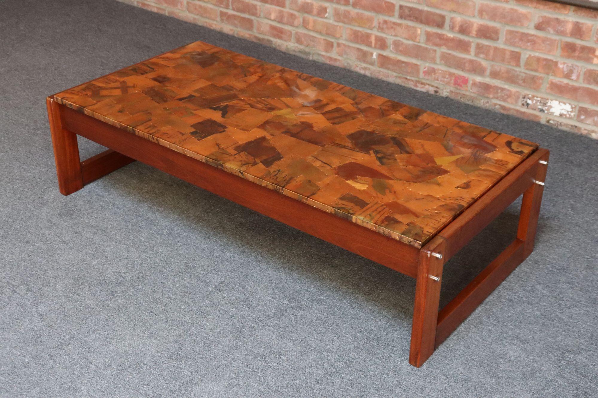 Sculptural coffee table designed by Percival Lafer composed of a visually striking copper patchwork/mosaic surface supported by deeply carved Brazilian Rosewood bases with exposed metal hardware. Coated in dense epoxy the surface is perfect for
