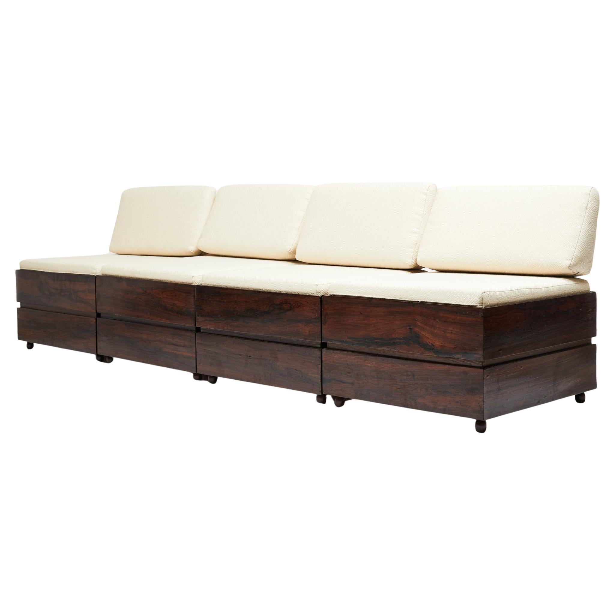 Available today, this magnificent set of four Brazilian Modern stool/trunks are made of solid Brazilian Rosewood (known as Jacaranda) and loose cushions (seat & backrest) in white cotton fabric. Each module has a lid that opens and closes for