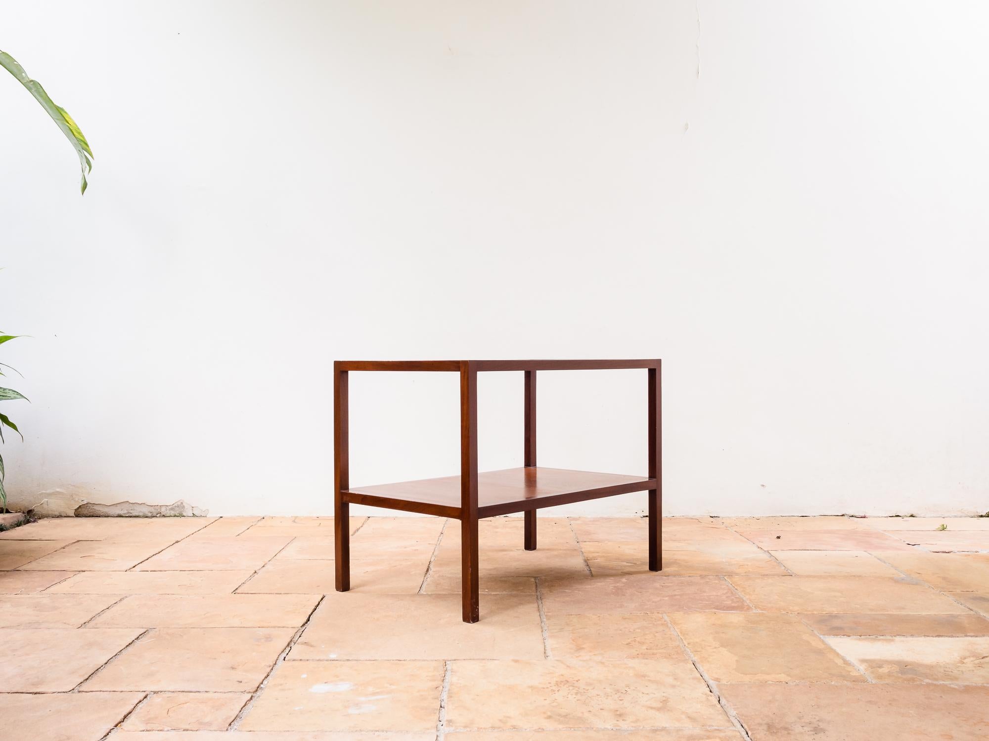 Brazilian Mid-Century Modern side table in Imbuia Hardwood and glass top, designed and produced by Joaquim Tenreiro, circa 1960.
This Minimalist side or end table is anything but simple upon closer inspection. The corner joints are reminiscent of