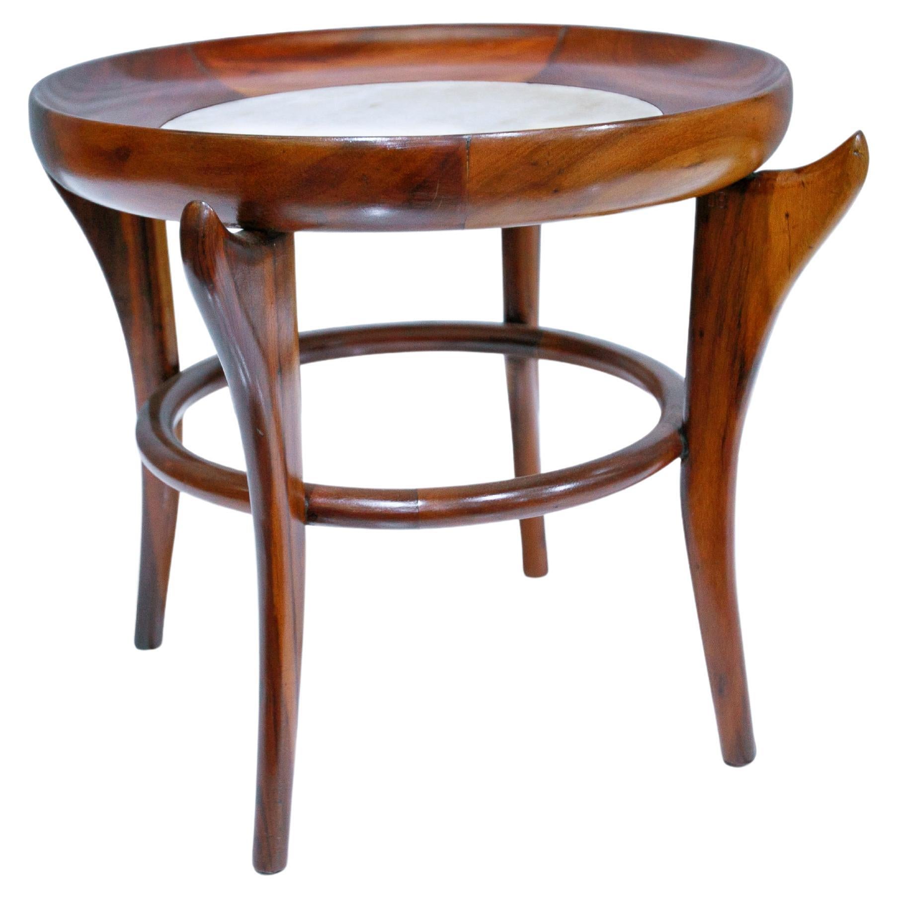 Available today, Giuseppe Scapinelli’s iconic Maracanã coffee table is made of Brazilian Rosewood, known as Jacaranda and marble. The top has a circular wood base that holds the marble, giving a futuristic look when seen from above. The four curved