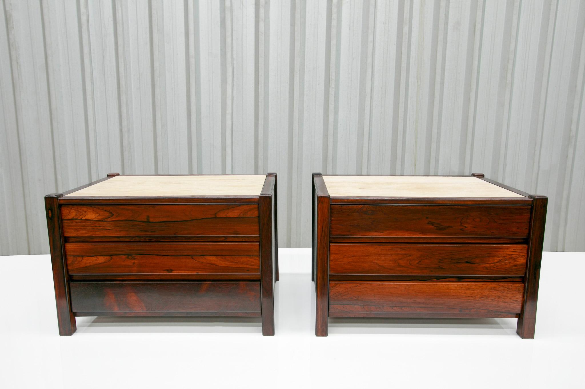 Available now, this Mid-Century Modern set of side tables in Travertine & Hardwood with drawers designed by Celina Decoracoes in the sixties are gorgeous! Each table is made with Brazilian rosewood with four legs, three drawers, and a travertine top